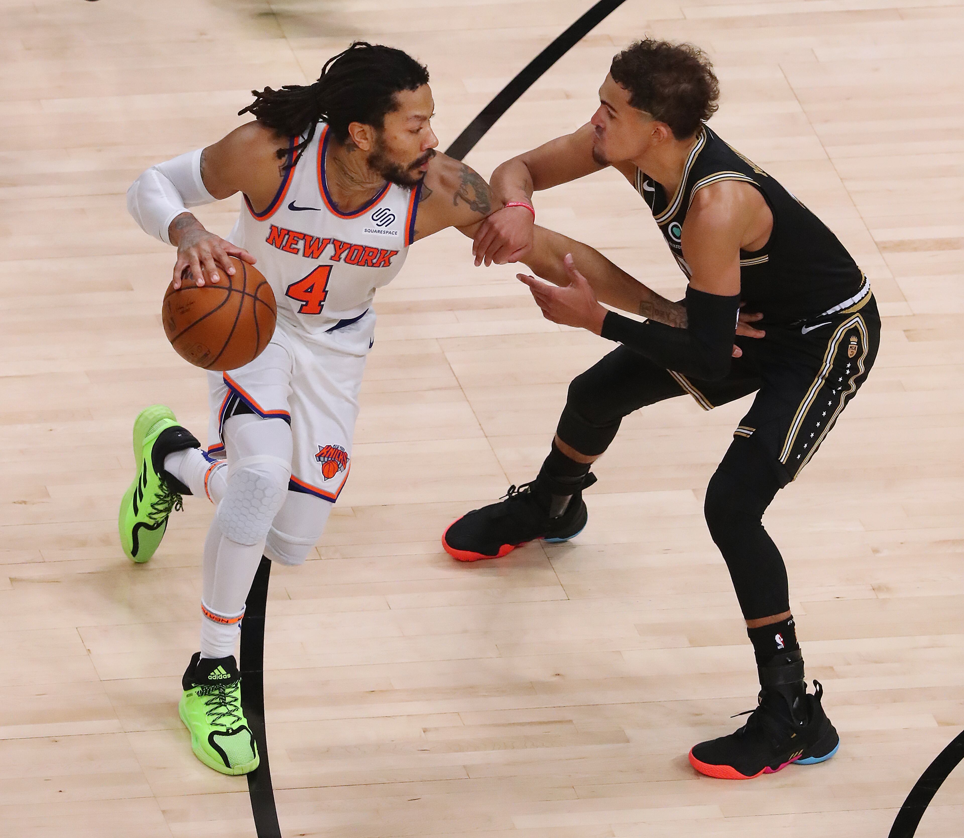Hawks guard Trae Young defends against New York Knicks guard Derrick Rose during Game 4 of their first-round NBA playoff matchup Sunday, May 30, 2021, at State Farm Arena in Atlanta. (Curtis Compton / Curtis.Compton@ajc.com)