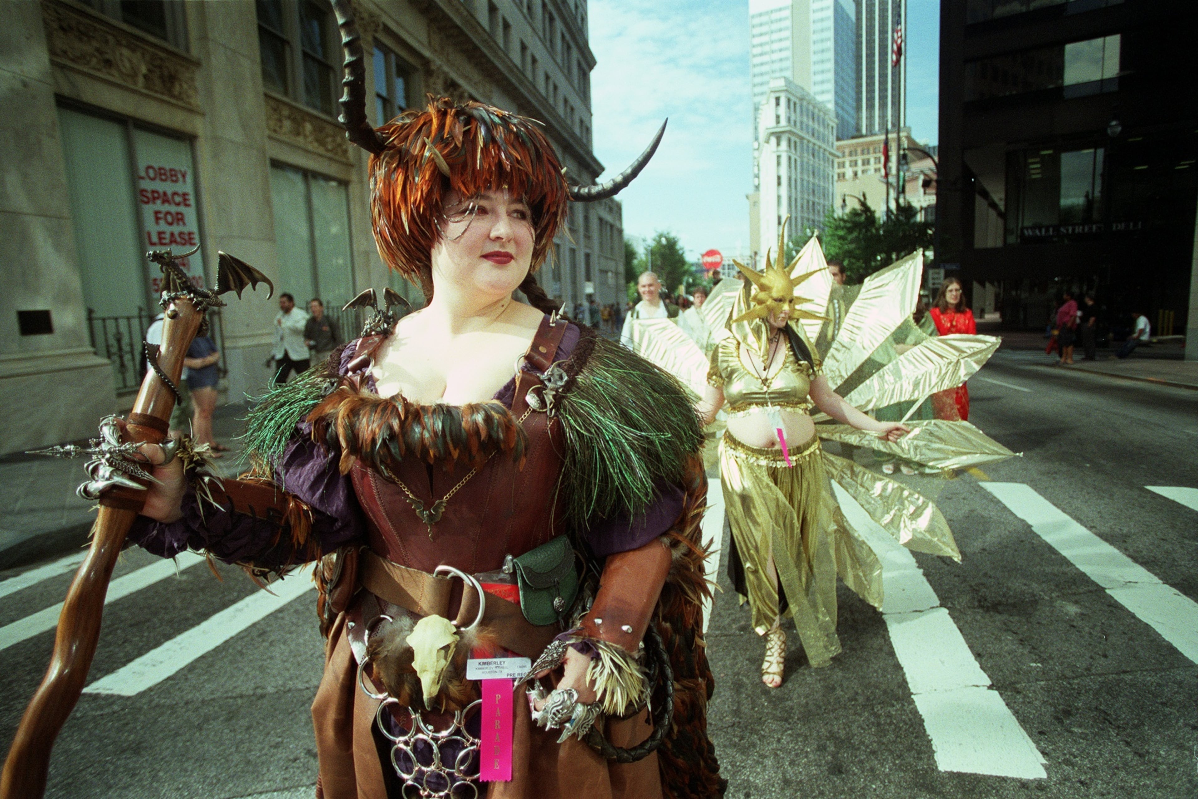 (From left) Kimberly Terrell, dressed as the warrior Rowan from the science fiction book "Wheel of Time," marches with Leah Chew, dressed as Ra, the Egyptian Sun Goddess, during the Dragon Con Parade on Aug. 30, 2003. "It's been fun to be around so many people with common interests," said Terrell. (Rebecca Reid for the AJC)