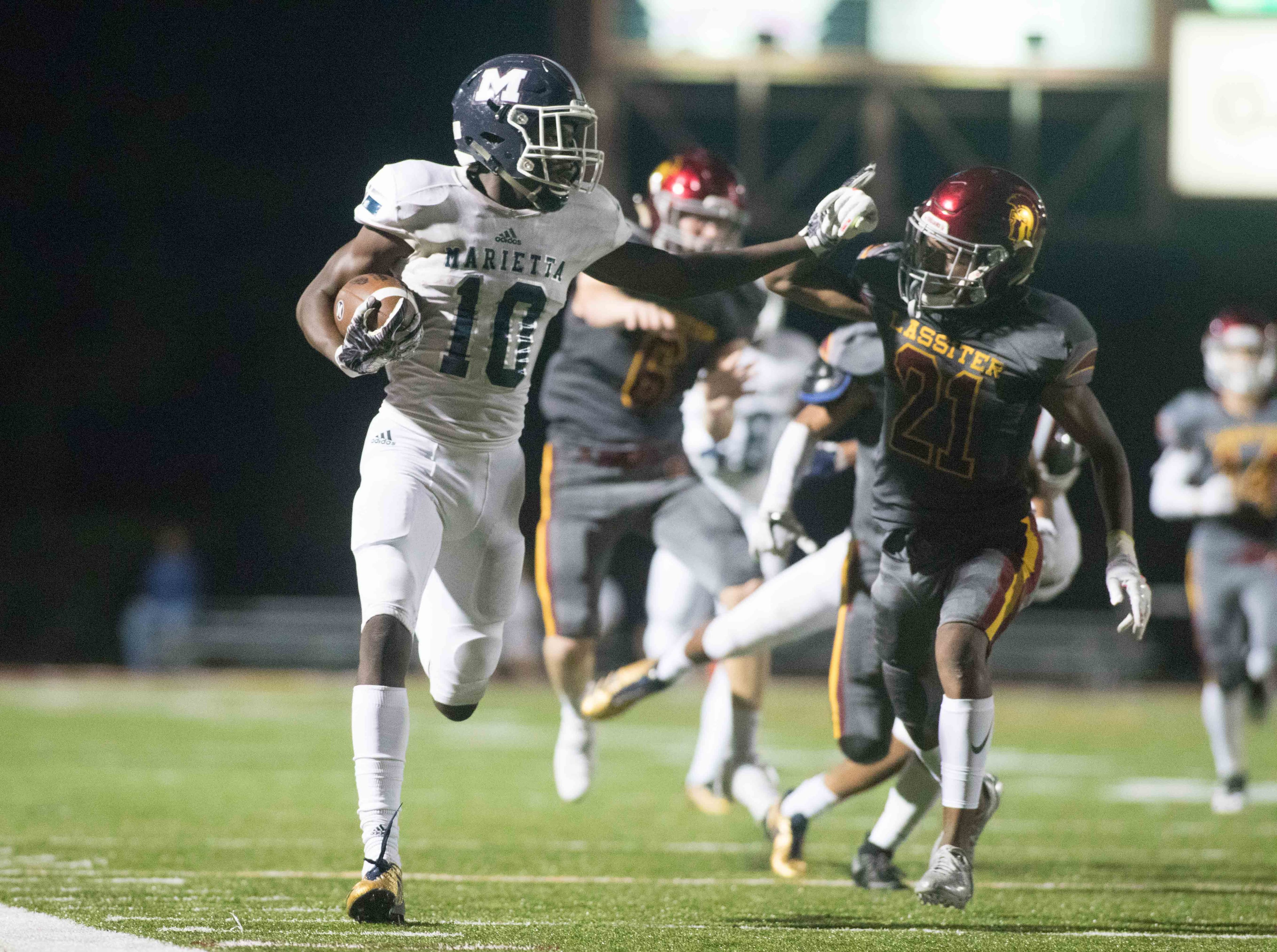 Marietta High School's Ramel Keyton (10) runs the ball while under pressure from Lassiter High School's Brandon Spencer (21) during the second half of a high school football game, Friday, Sept. 15, 2017, in Marietta, Ga. BRANDEN CAMP/SPECIAL