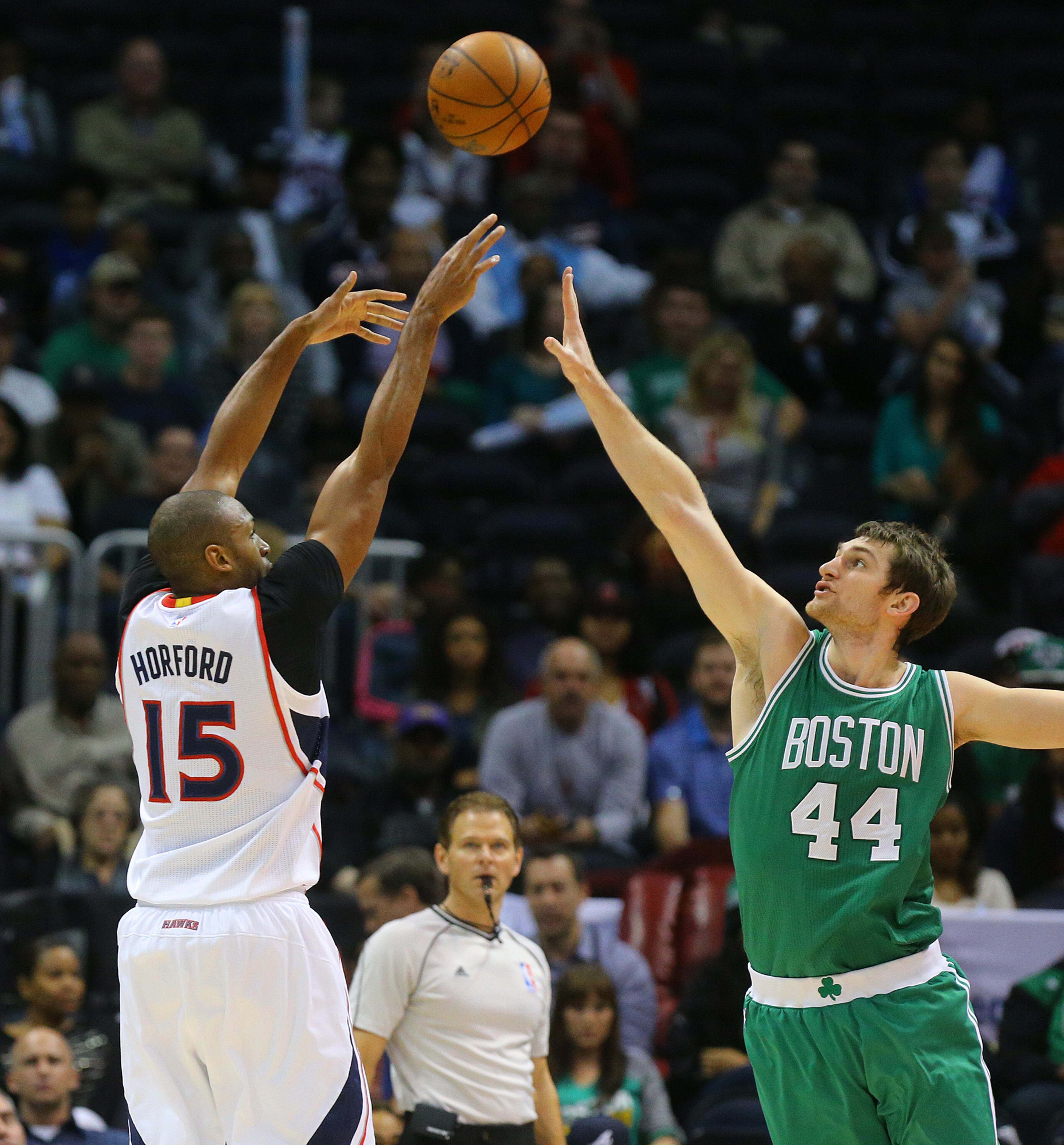 Hawks center Al Horford shoots over Celtics center Tyler Zeller during the first half in an NBA basketball game on Tuesday, Dec. 2, 2014, in Atlanta. CURTIS COMPTON / CCOMPTON@AJC.COM