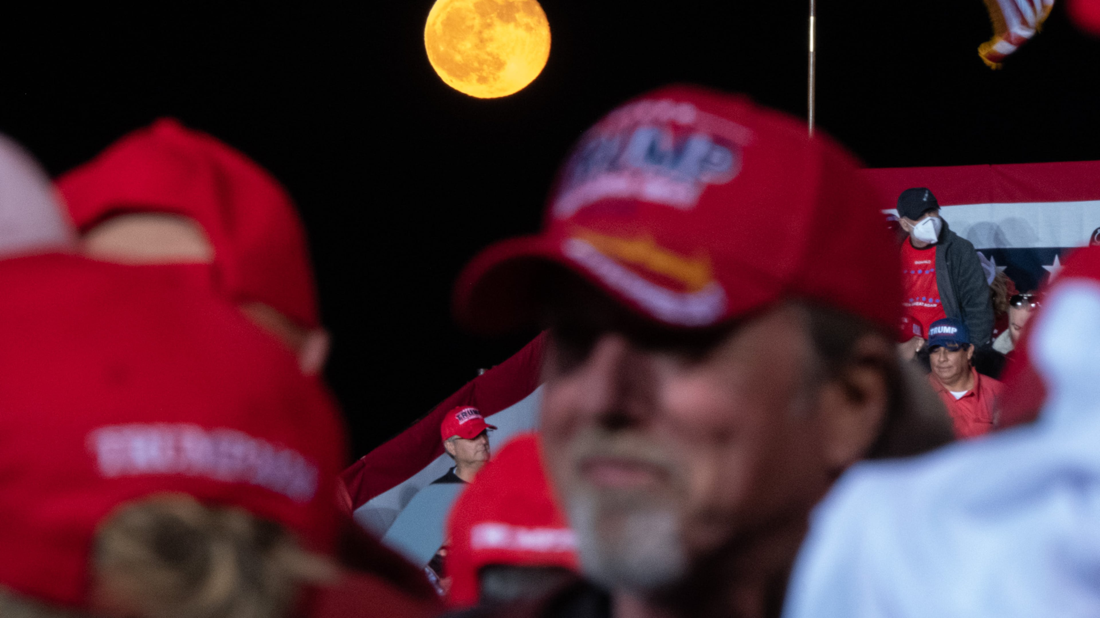 The moon rises behind supporters before the beginning of a President Donald Trump rally at Richard B. Russell Airport in Rome on Sunday evening, Nov. 1, 2020. A rally for his rival, Joe Biden, was canceled in Rome because Democrats said there was a threat from a militia presence. (Photo: Ben Gray for The Atlanta Journal-Constitution)