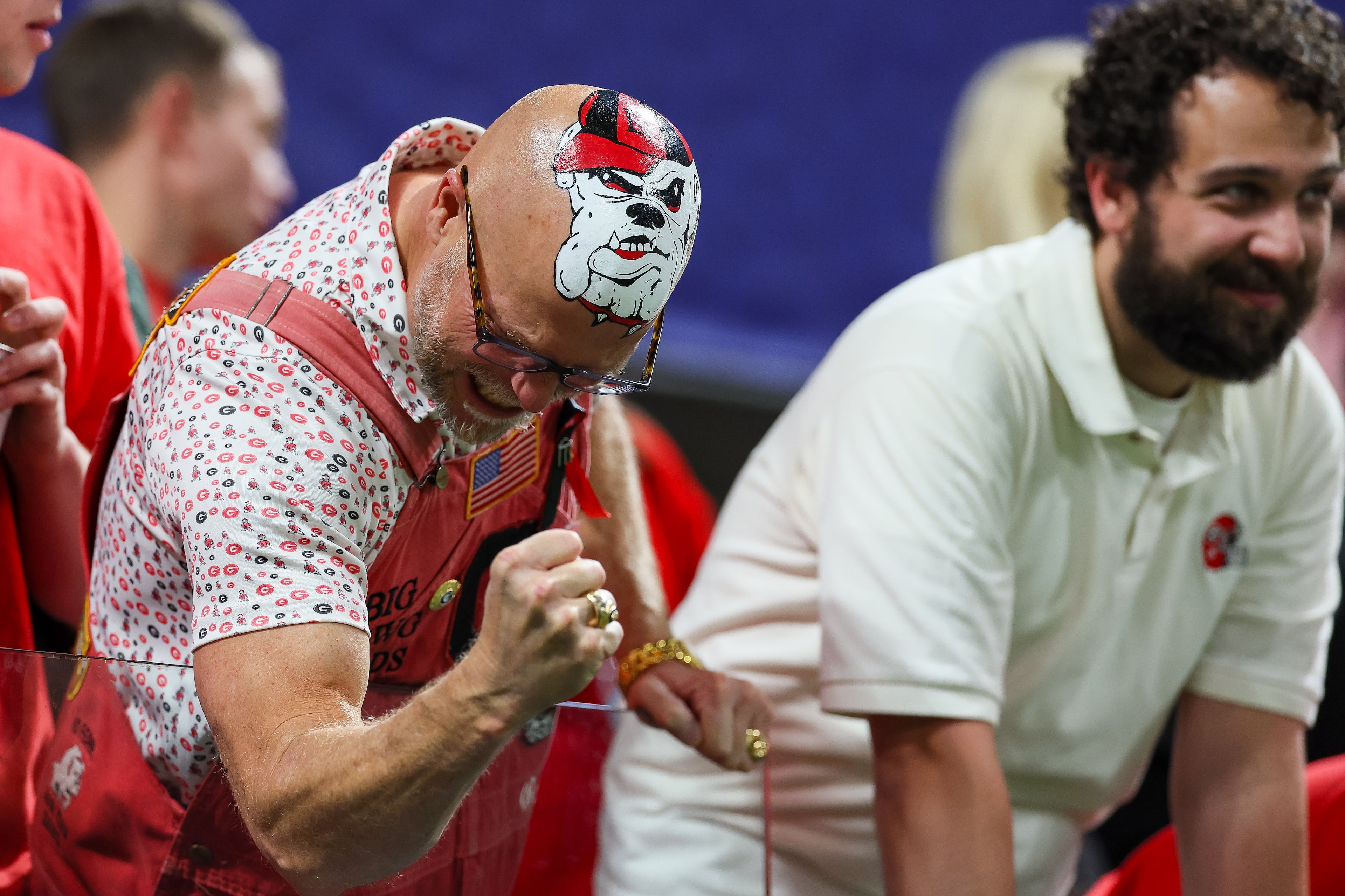 Georgia fan Mike Woods Jr. (left, celebrating at the SEC championship game) is ready for another ring.