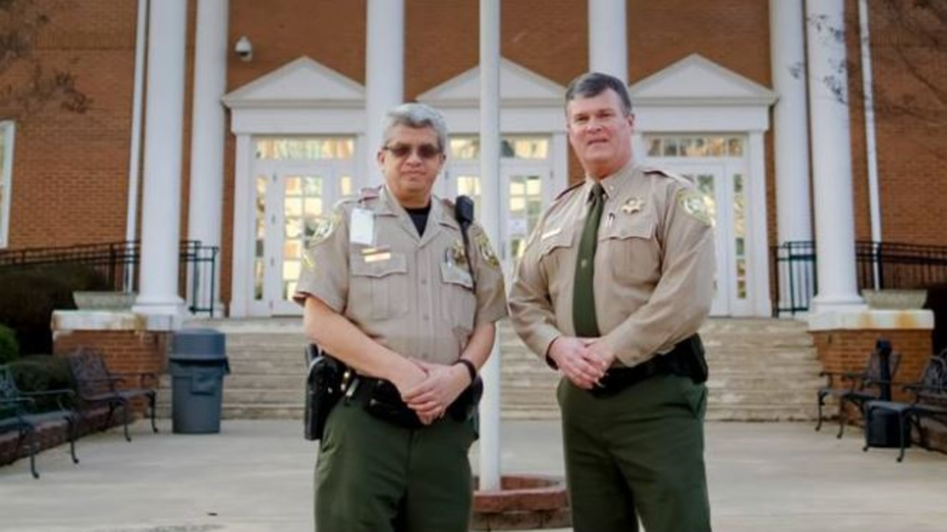 Forsyth County Deputy Daniel Rush (left), pictured with Sheriff Duane K. Piper, returned to work Monday after being shot in the leg during an attempted takeover of the county’s courthouse in June 2014. (Credit: Forsyth County Sheriff’s Office)