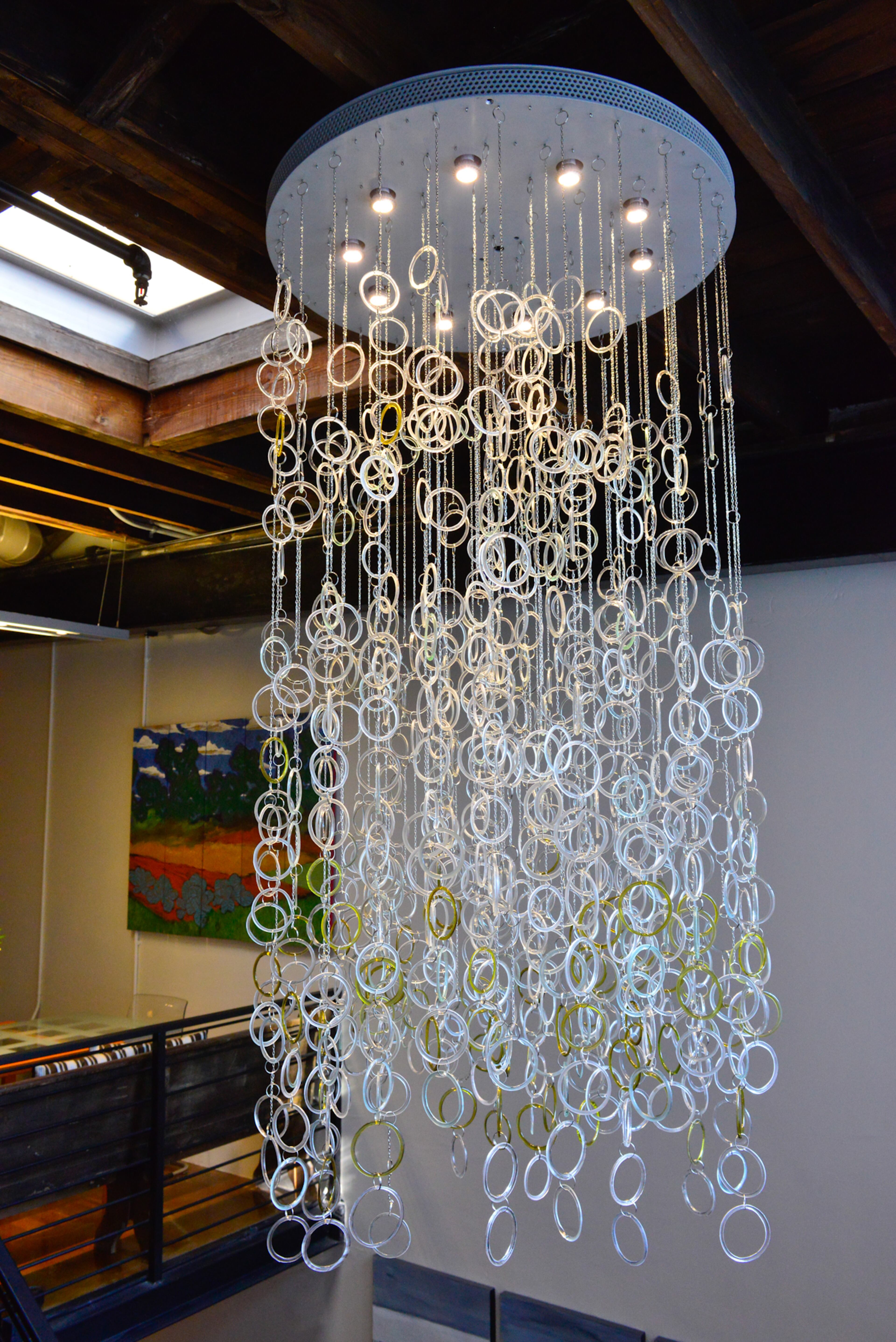 A new addition to the Atlanta loft that Thomas and Betsy Walsh purchased in 2012 is the recycled glass chandelier by Kathleen Plate of Smart Glass. They purchased the fixture in March at the American Craft Council Show in Atlanta as an anniversary present. The chandelier emphasizes the tall ceilings and open, airy feeling of the loft, which are the couple's favorite features of their new home.