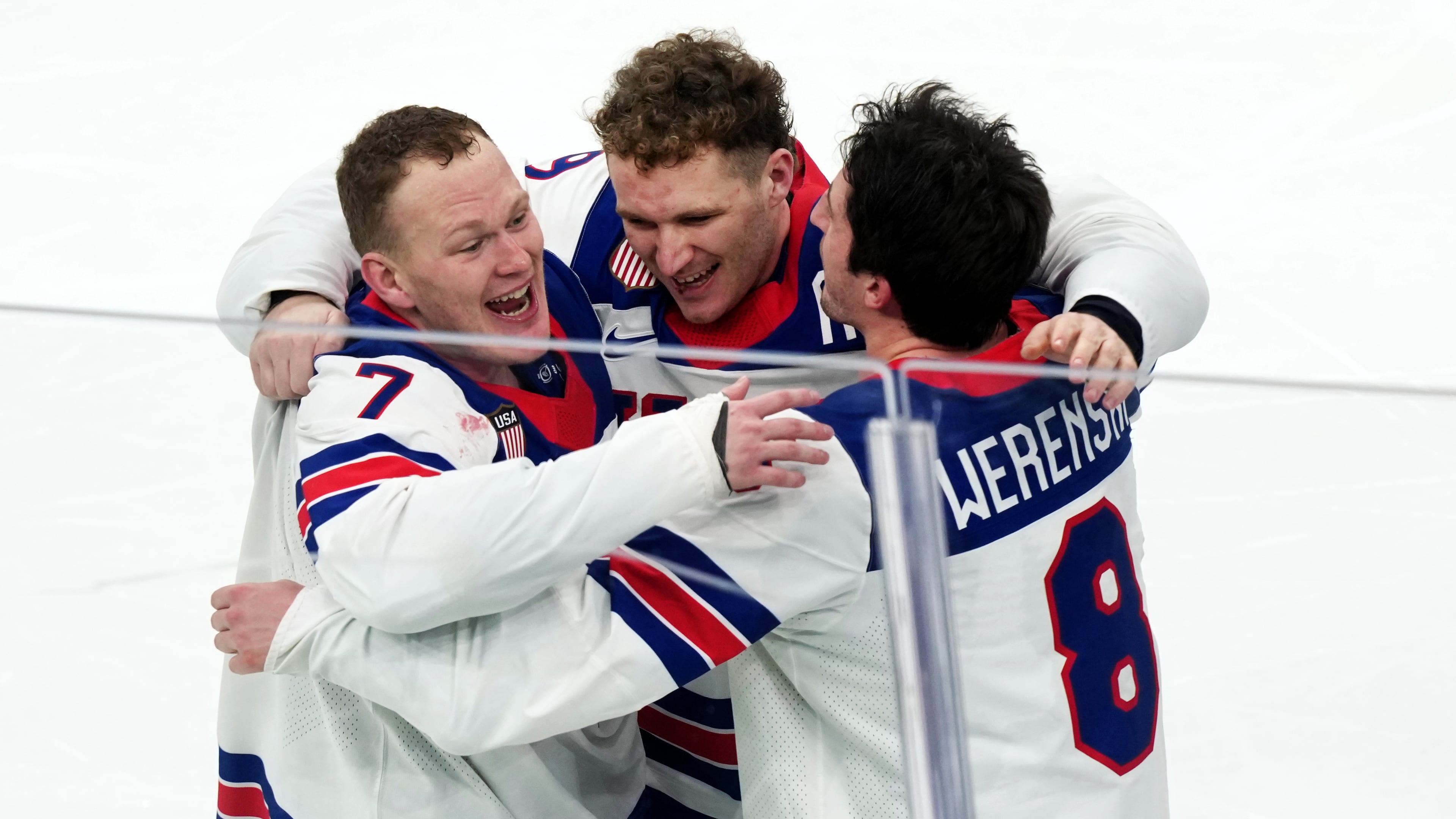 FILE - United States' Brady Tkachuk (7), Matthew Tkachuk, center, and Zach Werenski (8) celebrate after their overtime win against Canada in the men's ice hockey gold medal game at the 2026 Winter Olympics in Milan on Feb. 22, 2026. (AP Photo/Carolyn Kaster, File)