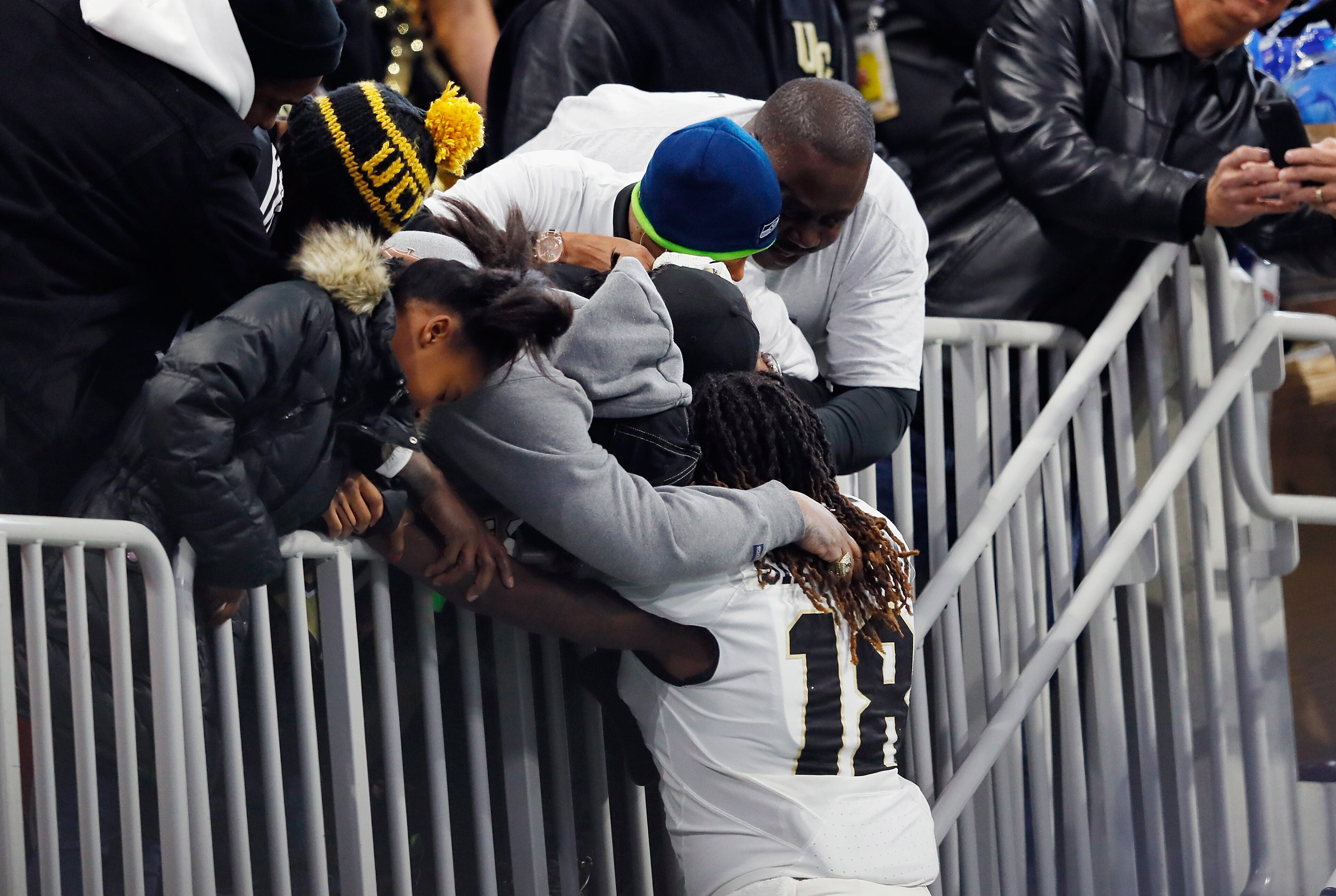 ATLANTA, GA - JANUARY 01: Shaquem Griffin #18 of the UCF Knights hugs family members before the Chick-fil-A Peach Bowl against the Auburn Tigers at Mercedes-Benz Stadium on January 1, 2018 in Atlanta, Georgia. (Photo by Kevin C. Cox/Getty Images)