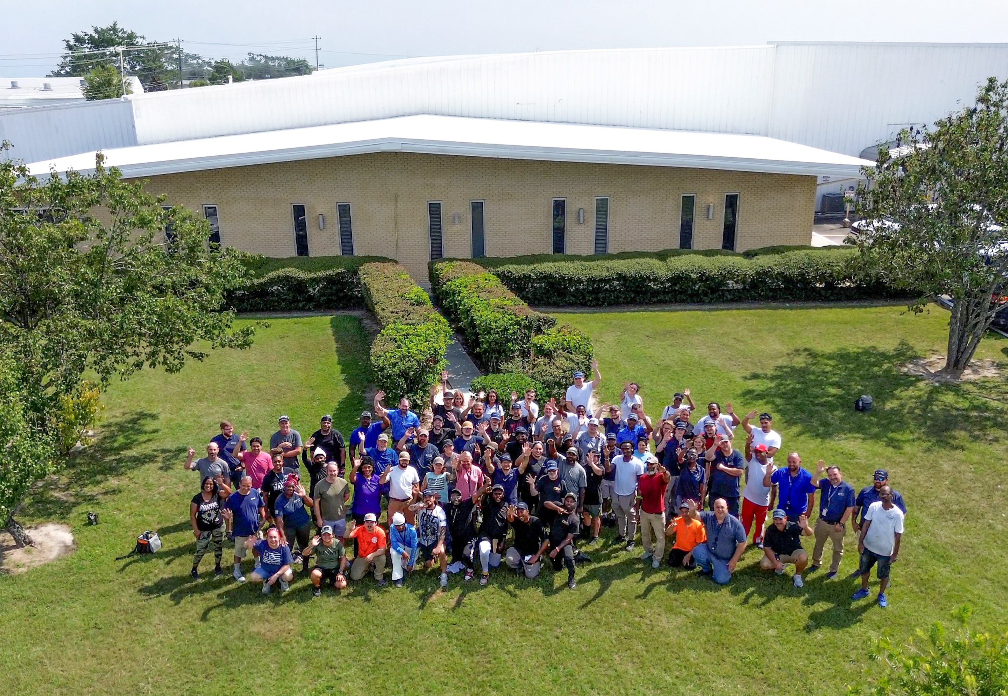 Blue Ops employees stand outside the company's Valdosta manufacturing facility, where the company assembled autonomous marine boats. (Courtesy of Blue Ops)