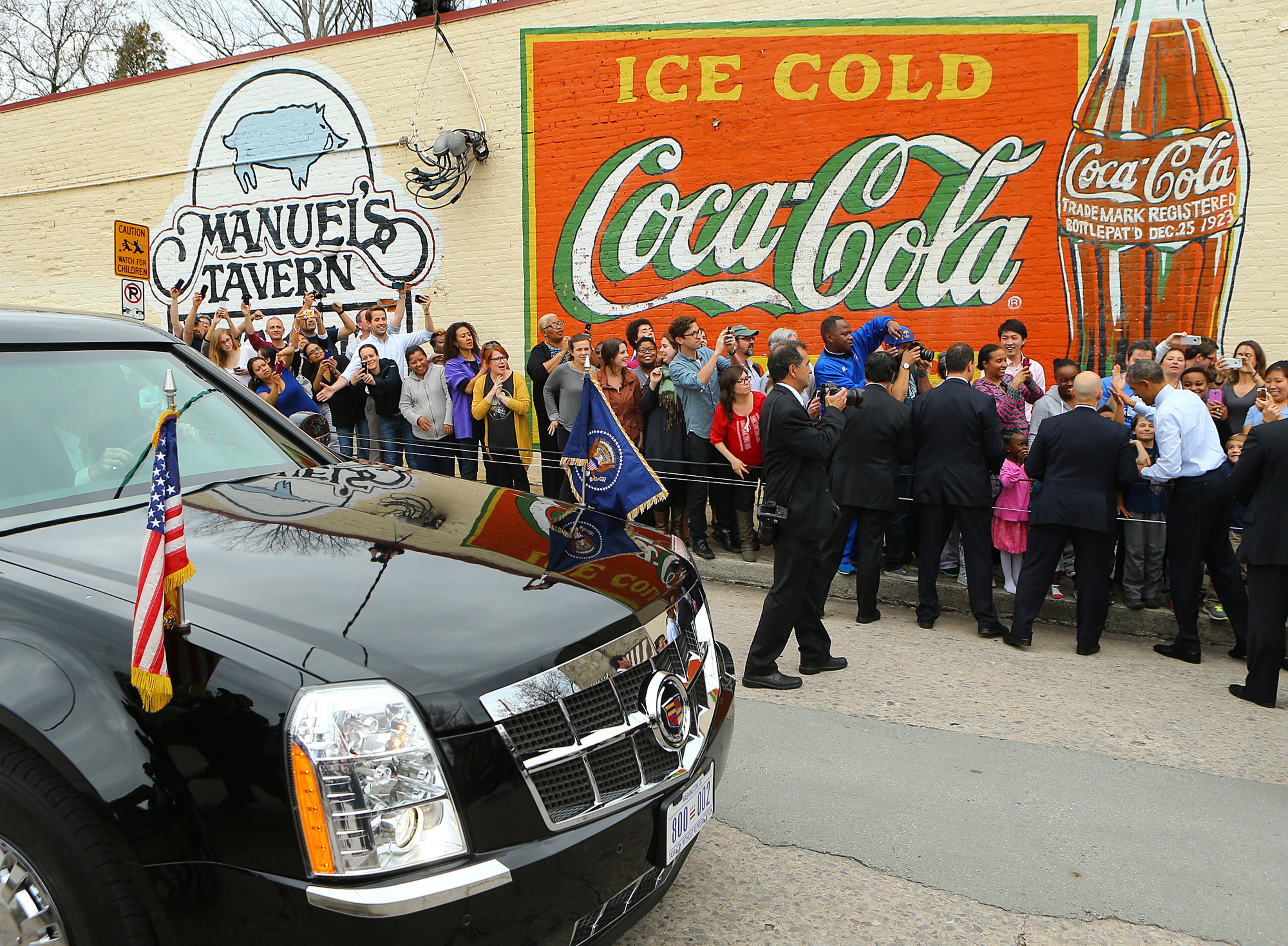 President Barack Obama high fives the crowd as he leaves Manuel's Tavern on Tuesday, March 10, 2015, in Atlanta. Curtis Compton / ccompton@ajc.com