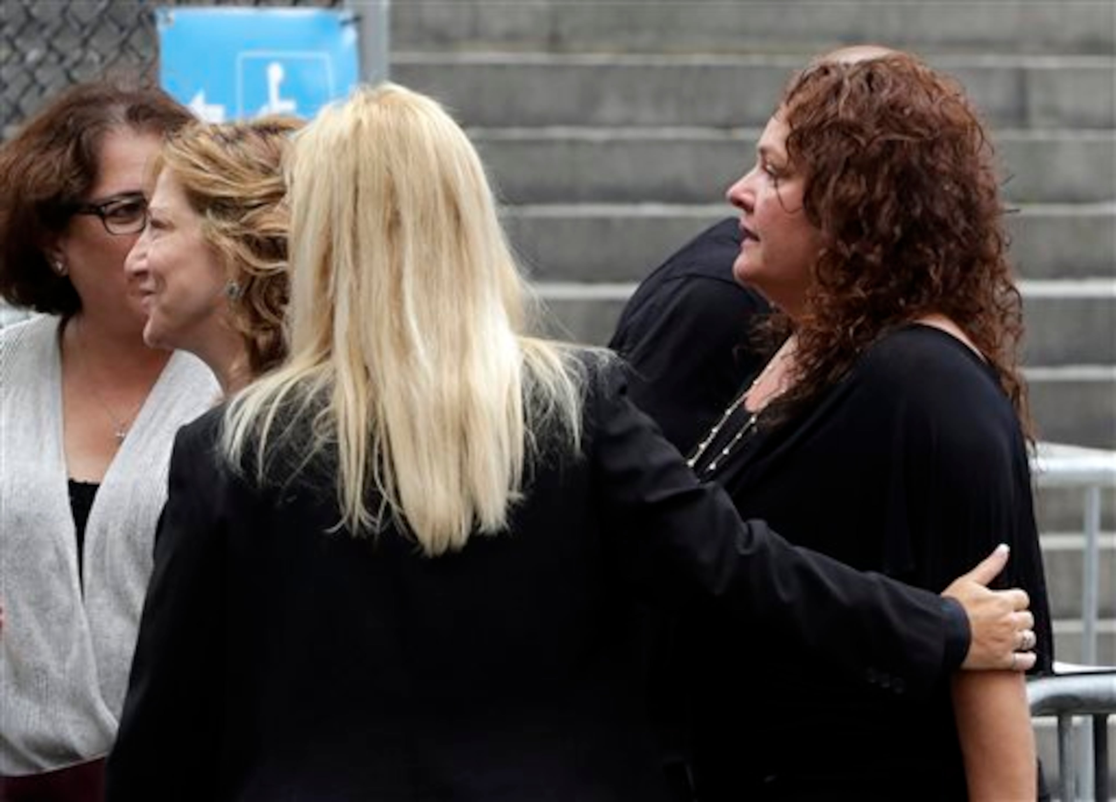 Actresses Edie Falco, second left, and Aida Turturro, right, arrive for the funeral service of James Gandolfini, star of "The Sopranos," in New York's the Cathedral Church of Saint John the Divine, Thursday, June 27, 2013. The 51-year-old actor died of a heart attack last week while vacationing in Italy with his son.(AP Photo/Richard Drew)