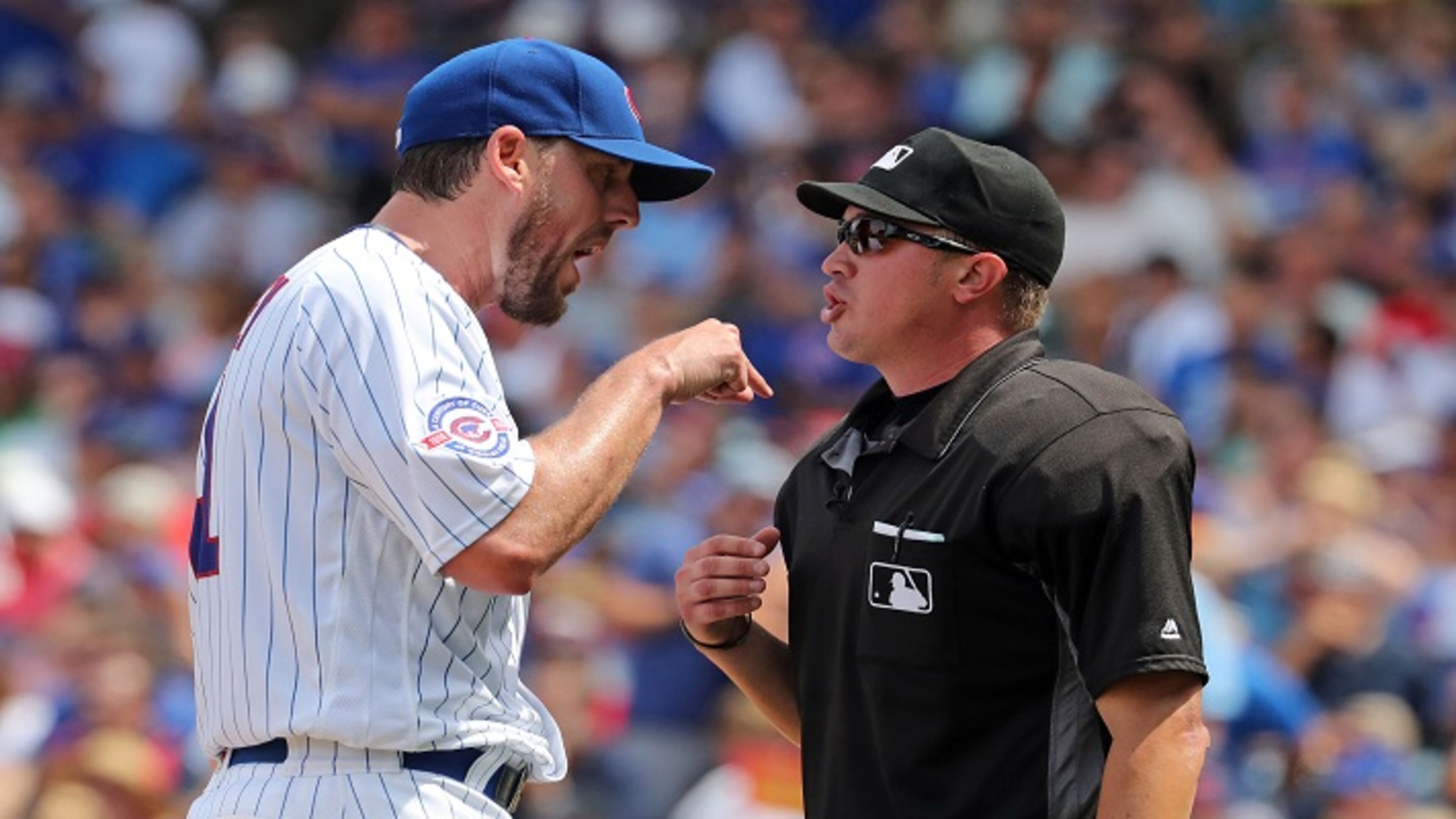 Chicago Cubs starting pitcher John Lackey (41) has an argument with umpire Cory Blaser (89) after finishing the sixth inning on Sunday, July 17, 2016, at Wrigley Field in Chicago, Ill. (Brian Cassella/Chicago Tribune/TNS)