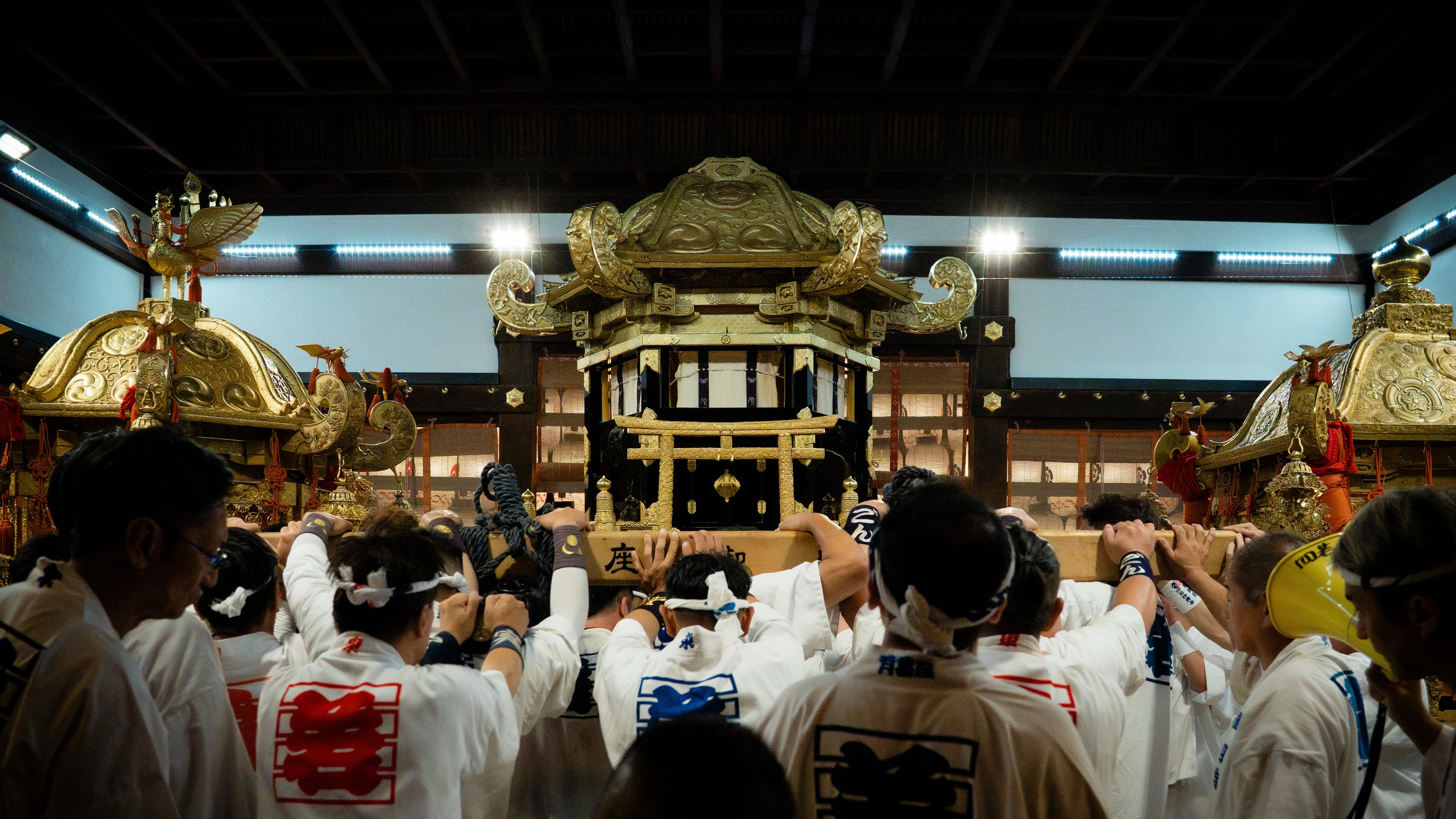Festival participants carry Yasaka Shrine's Eastern Mikoshi back into the shrine's main hall following the "Mikoshi Arai" purification ritual ahead of the Gion Matsuri festival in Kyoto, western Japan, Friday, July 10, 2026. (AP Photo/Fred Mery)