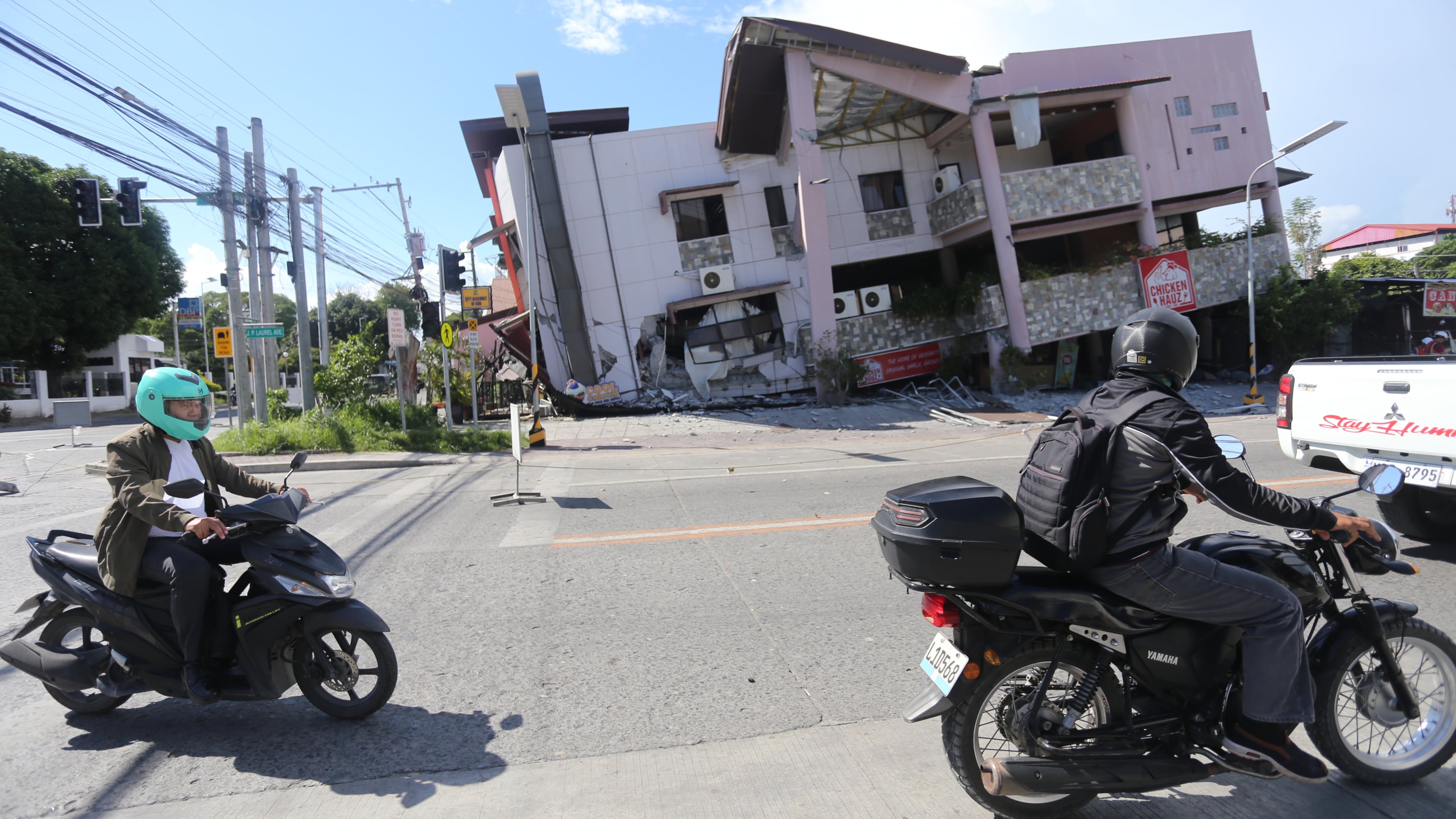 People on motorcycles pass by a collapsed structure after an earthquake in General Santos, Philippines on Monday, June 8, 2026. (AP Photo)