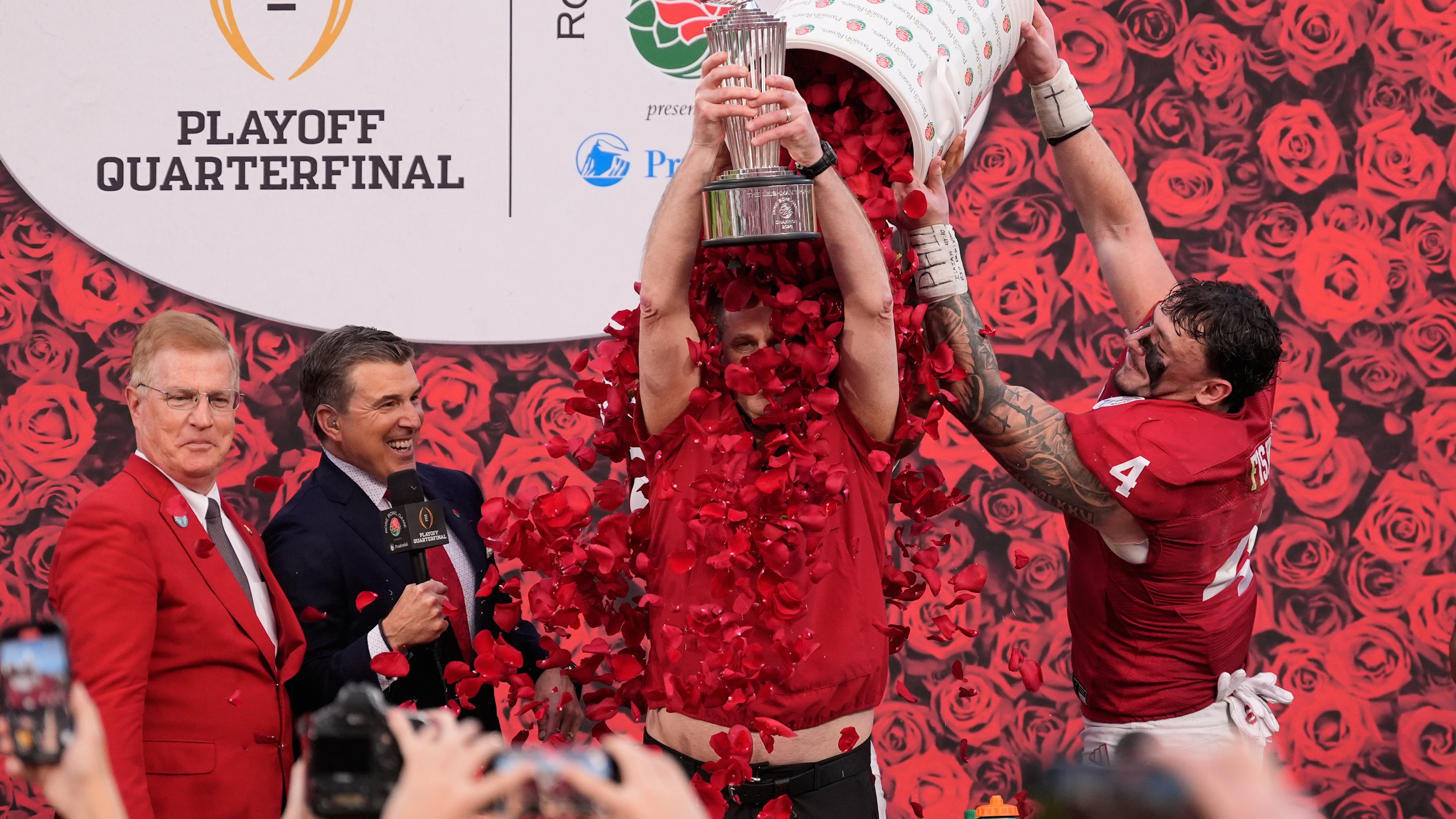 Indiana head coach Curt Cignetti holds the winner's trophy as he is doused with rose pedals by linebacker Aiden Fisher (4) after a win over Alabama in the Rose Bowl College Football Playoff quarterfinal game Thursday, Jan. 1, 2026, in Pasadena, Calif. (AP Photo/Mark J. Terrill)