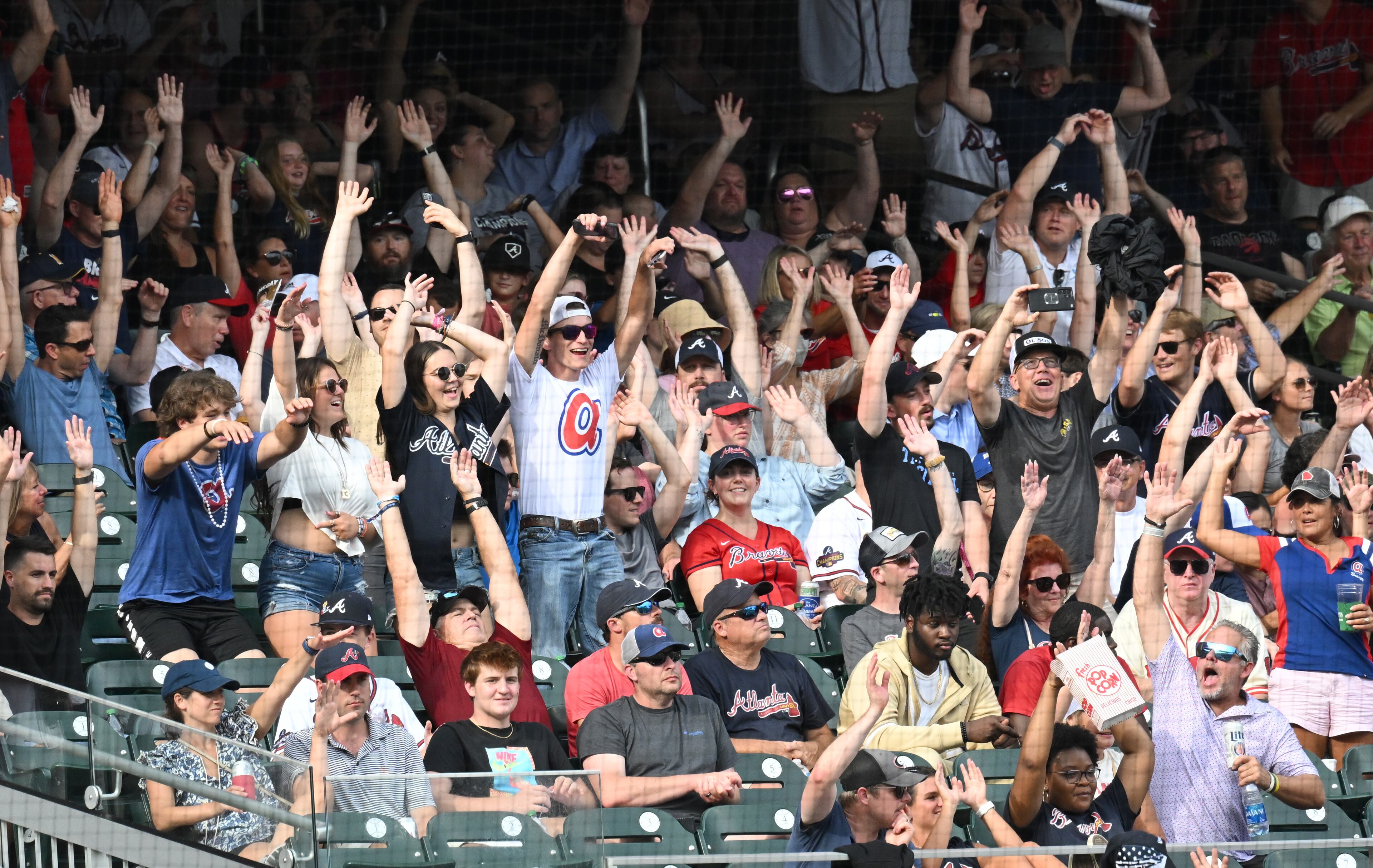 Braves fans cheer in the 9th inning at Truist Park on Saturday, July 9, 2022. Atlanta Braves won 4-3 over Washington Nationals. (Hyosub Shin / Hyosub.Shin@ajc.com)