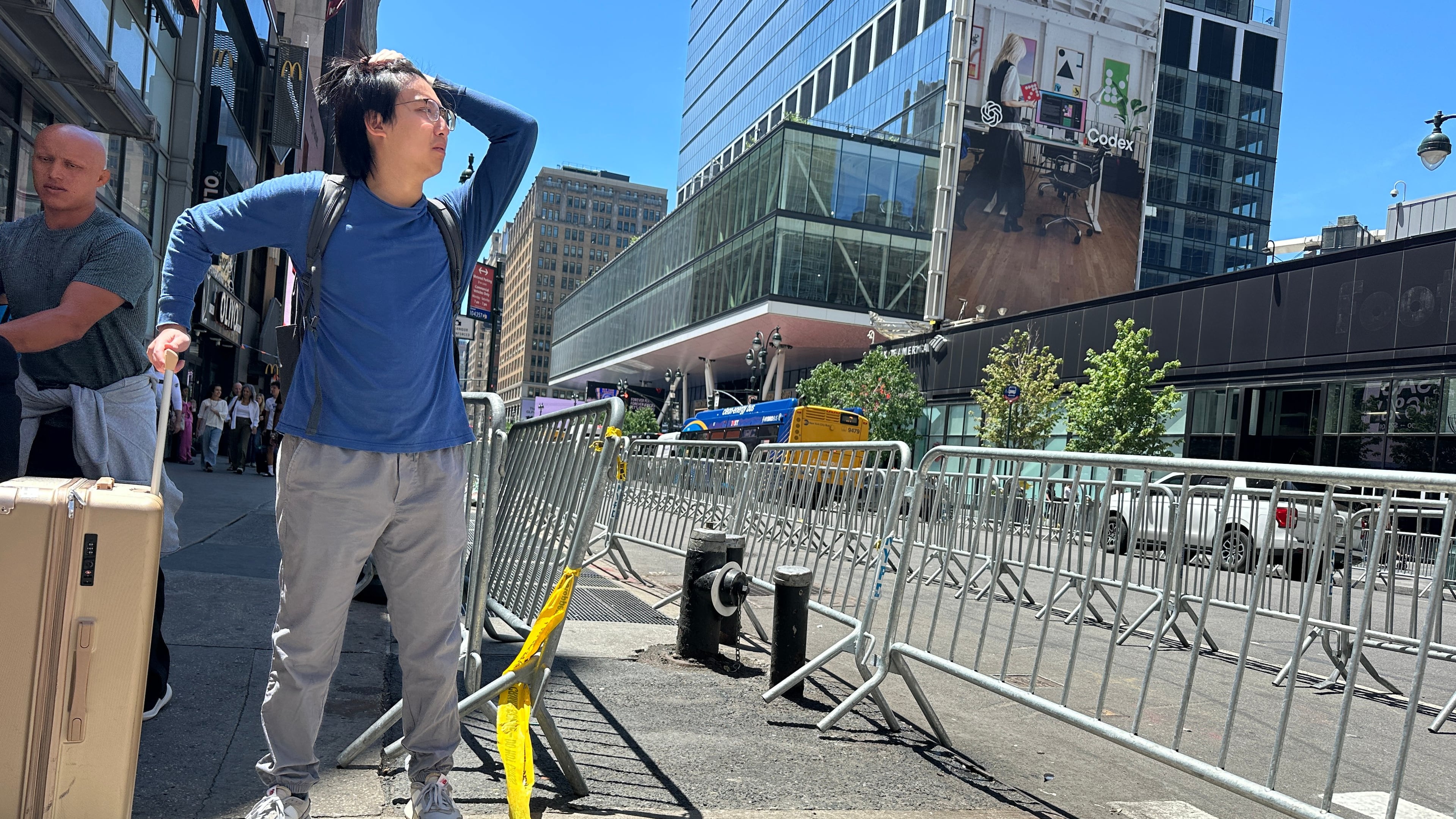 A traveler tries to navigate the area as stringent security measures are set up outside of Madison Square Garden in New York, Monday, June 8, 2026, as President Donald Trump is set to attend Game 3 of the NBA Finals basketball series between the New York Knicks and the San Antonio Spurs. (AP Photo/Ted Shaffrey)