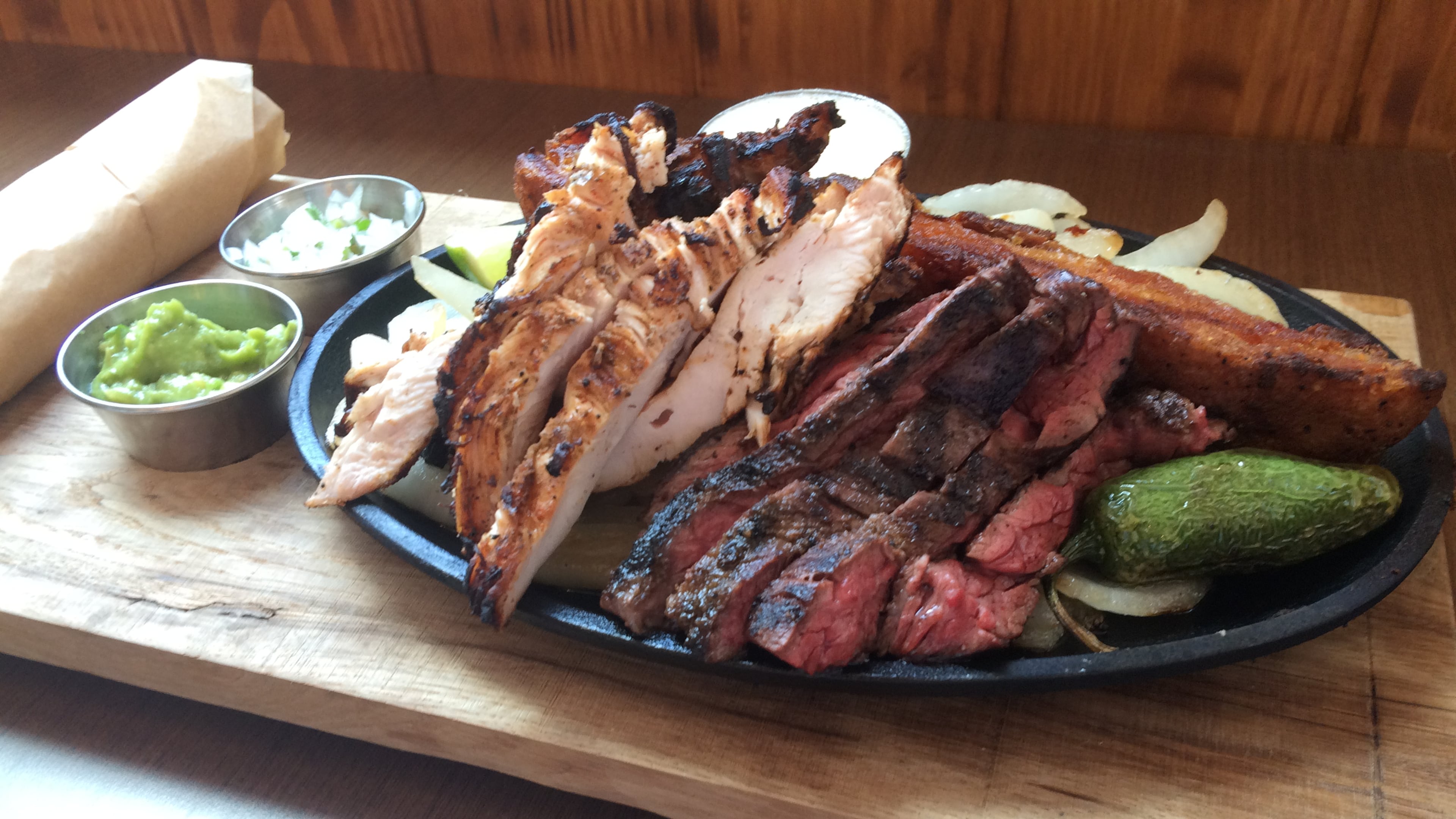 The Parilla Mixta Fajita at Superica includes beef and chicken fajitas, carnitas, guacamole, smoked onion salsa fresca, Mexican butter and house-made flour tortilllas. Photo: Ligaya Figueras