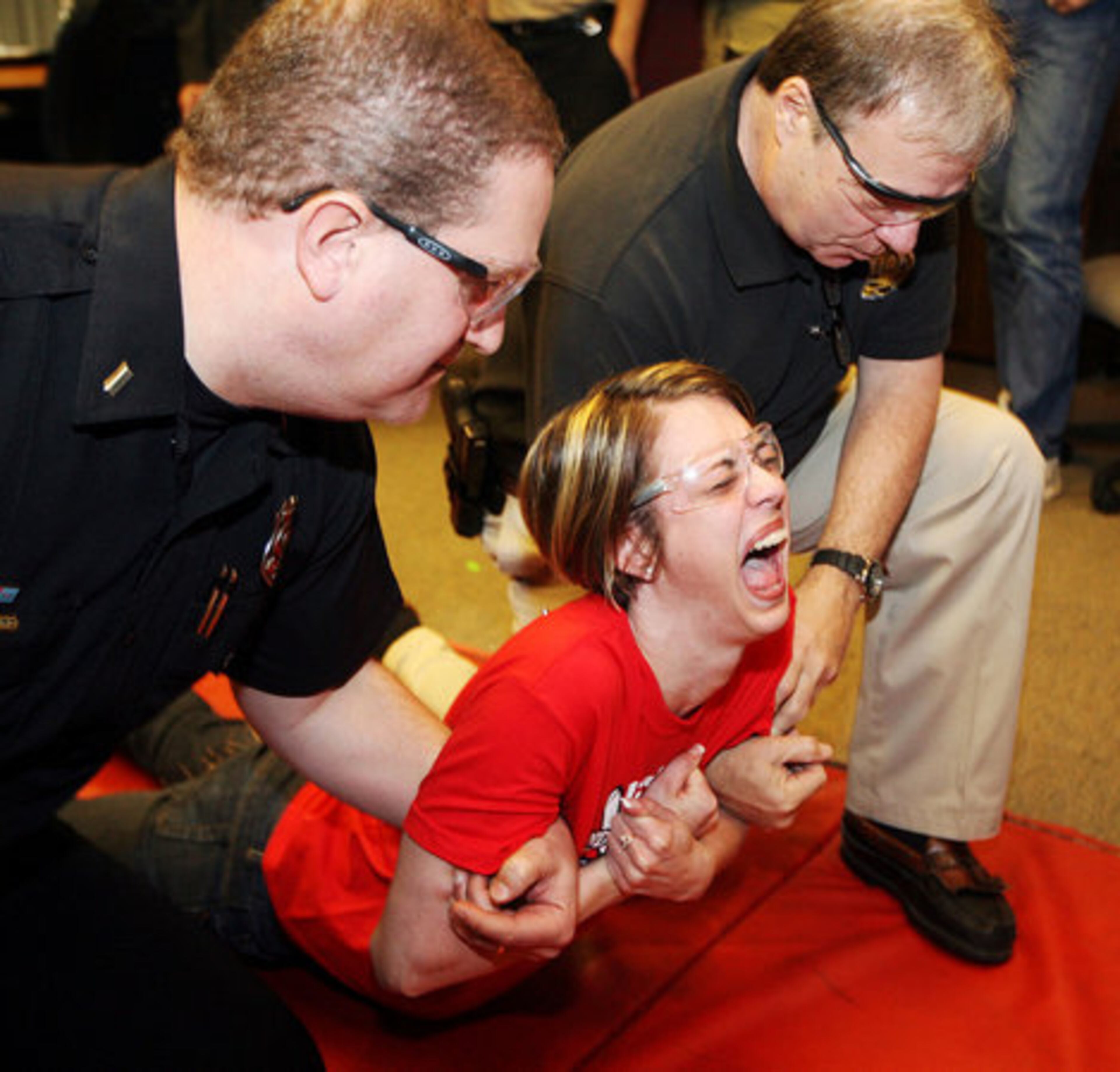 Paalaen's jaw locks and she can't make a sound for the five-second taser duration as she was gently lowered to the ground by Roskind and Rose.