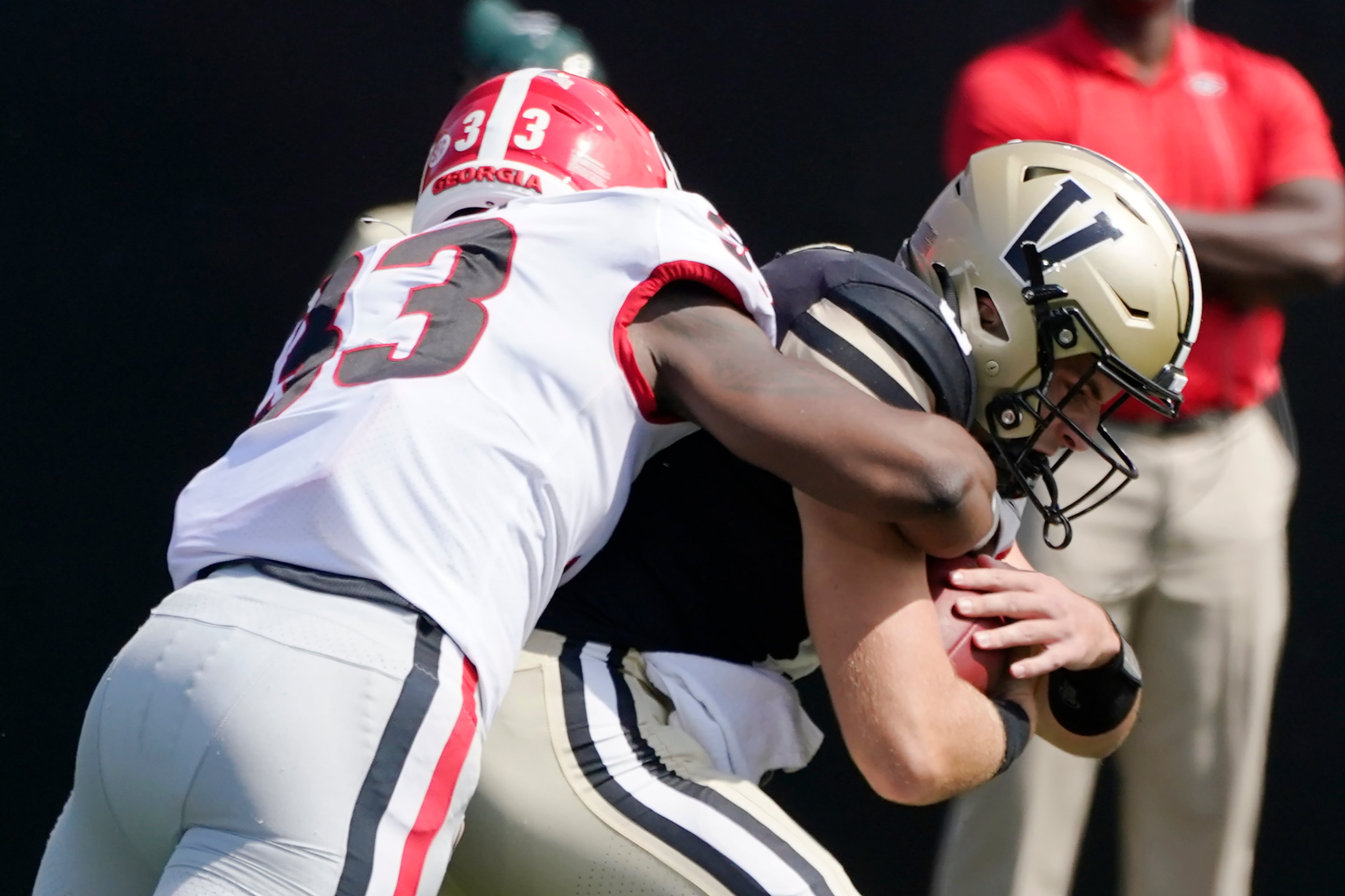 Georgia linebacker Robert Beal Jr. (33) sacks Vanderbilt quarterback Ken Seals for a 10-yard loss in the second half of an NCAA college football game Saturday, Sept. 25, 2021, in Nashville, Tenn. Georgia won 62-0. (AP Photo/Mark Humphrey)
