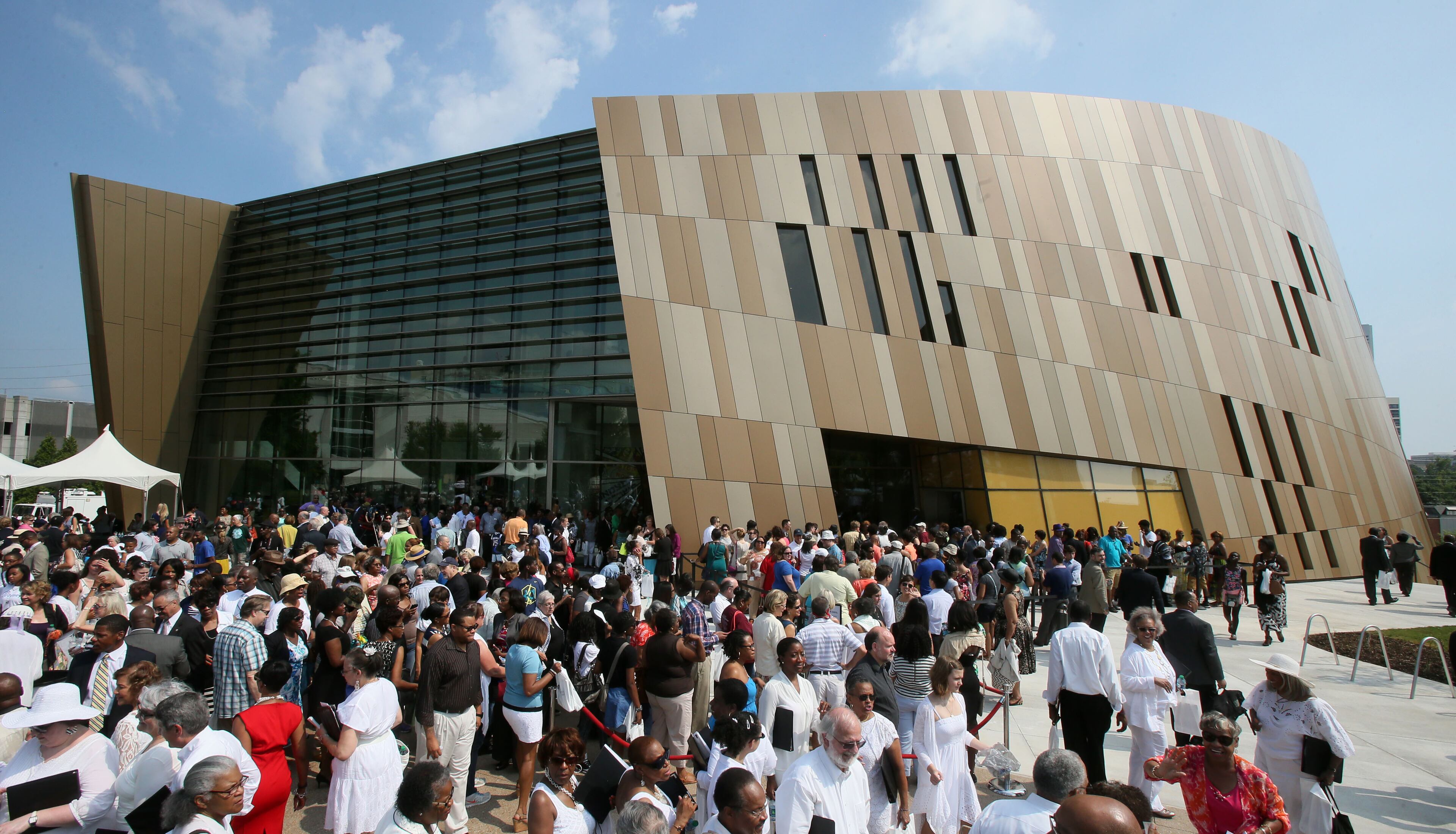 Crowds gather around the center after the ceremony to line up for the opening at noon. The National Center for Civil and Human Rights held its grand opening celebration with a 10 a.m. public ceremony outside in the plaza at Pemberton Place in advance of a noon opening. The ceremony included speeches, and a choir which concluded the ceremony with an emotional performance of "We Shall Overcome." BOB ANDRES / BANDRES@AJC.COM