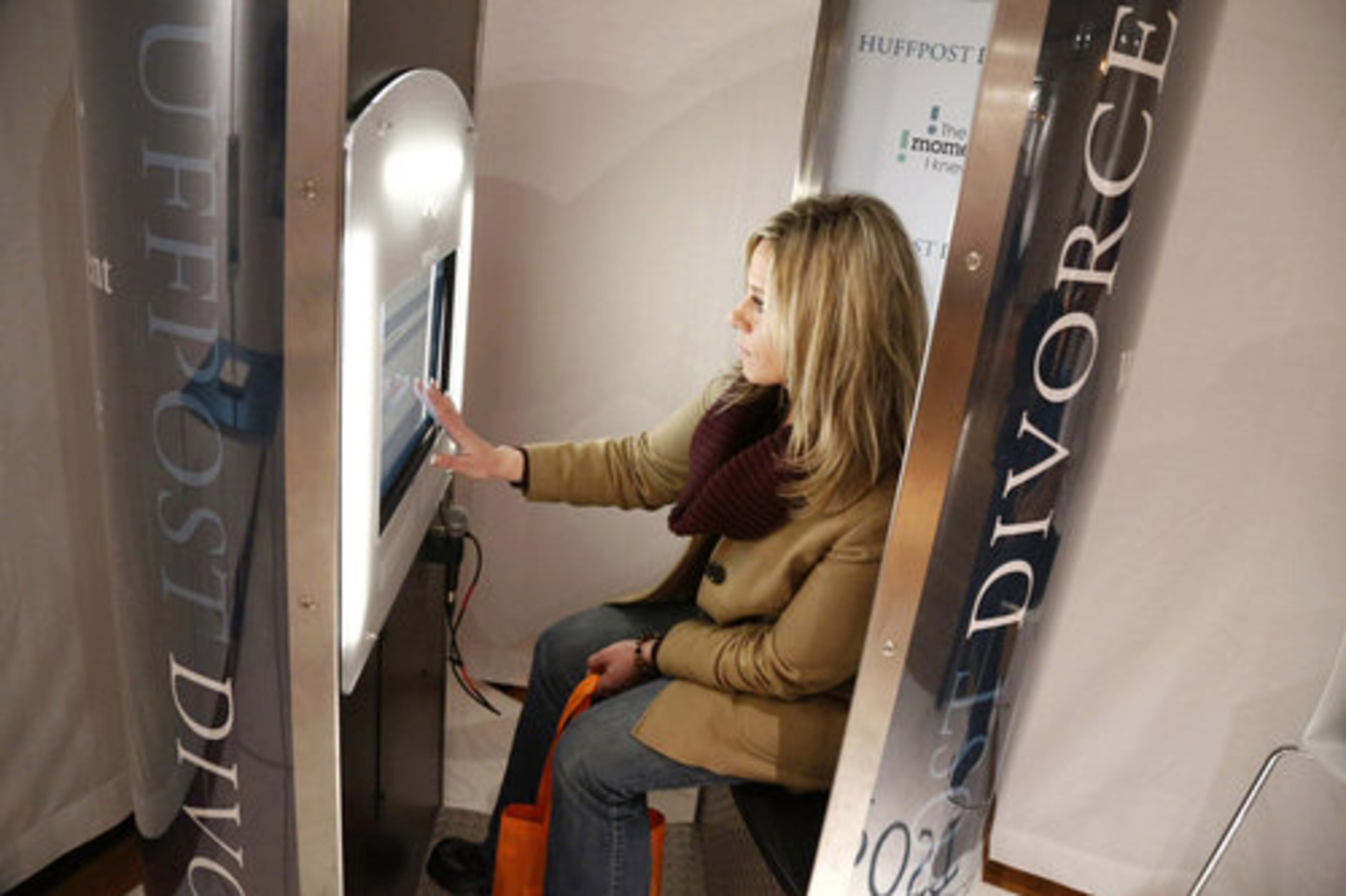 Attendee Liz Slayback of the Staten Island borough of New York, visits a booth sponsored by the Huffington Post.