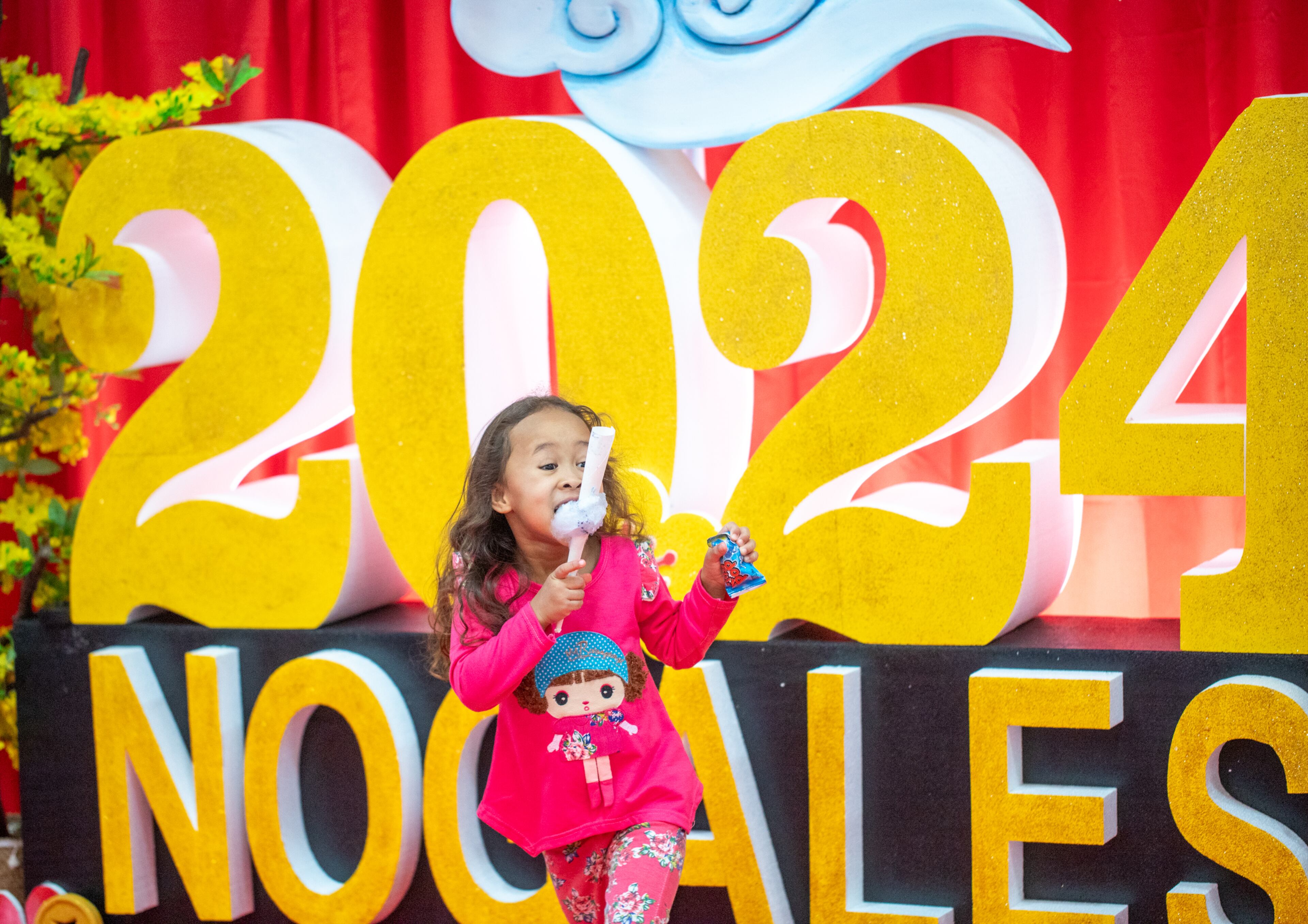 Maya Lavalais 5, brings in the new year with cotton candy on Saturday, Feb 3, 2024. The Vietnamese American Community of Georgia hosts a Lunar New Year celebration at Plaza Las Americas in Lilburn where dragon and lion dancing began the weekend. The celebration continues on Sunday and includes traditional food, music and cultural festivities. (Jenni Girtman for The Atlanta Journal-Constitution)