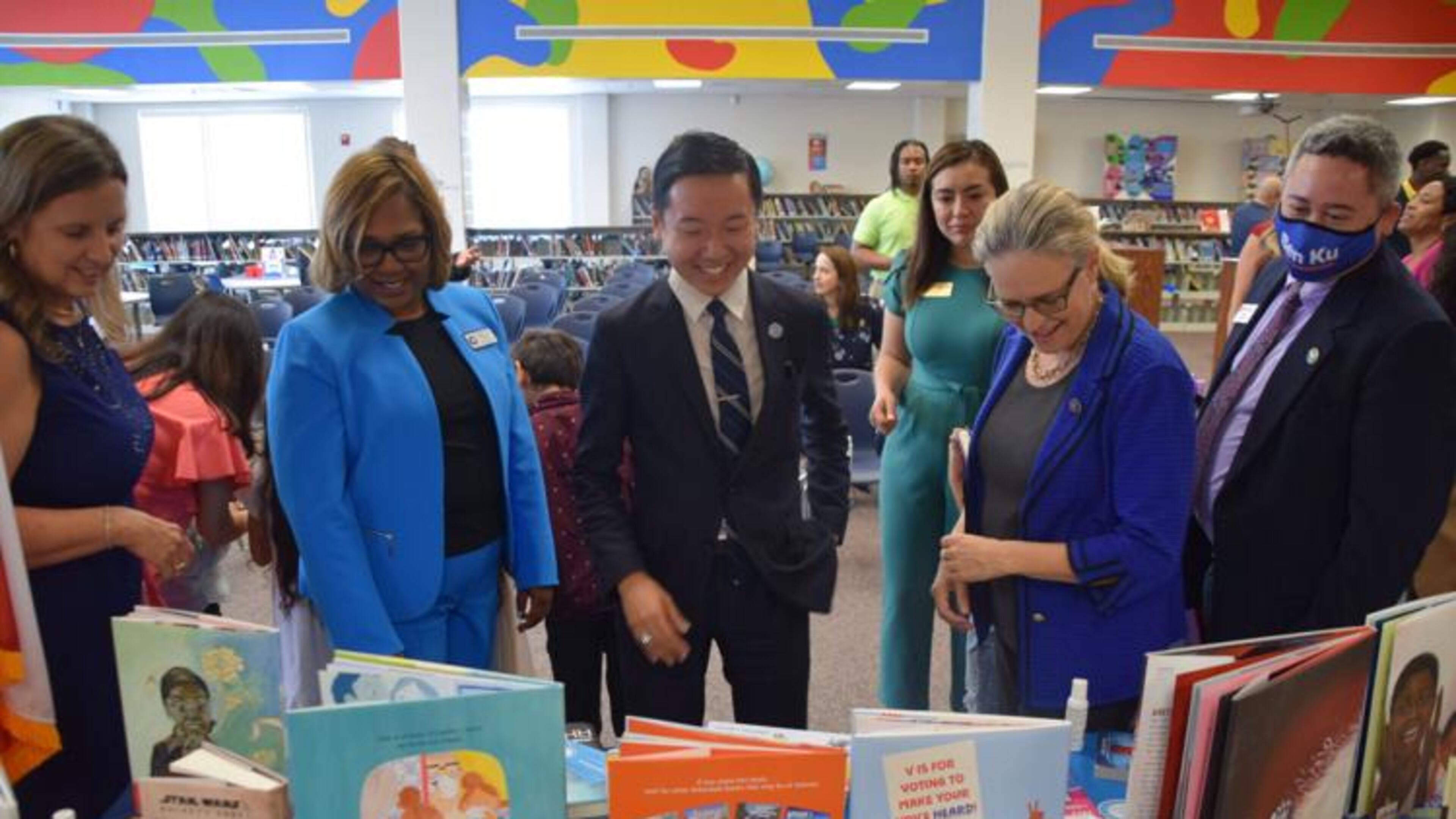 J.T. Wu, center. the founder of literacy education nonprofit, Preface, talks to Graves Elementary School officials, including Principal Monica Ball, second from the left, as well as U.S. Rep. Carolyn Bourdeaux, second from the right, and Gwinnett County Commissioner Ben Ku, right, about the multilingual books that Preface donated to the school's library. (Courtesy of Curt Yeomans)
