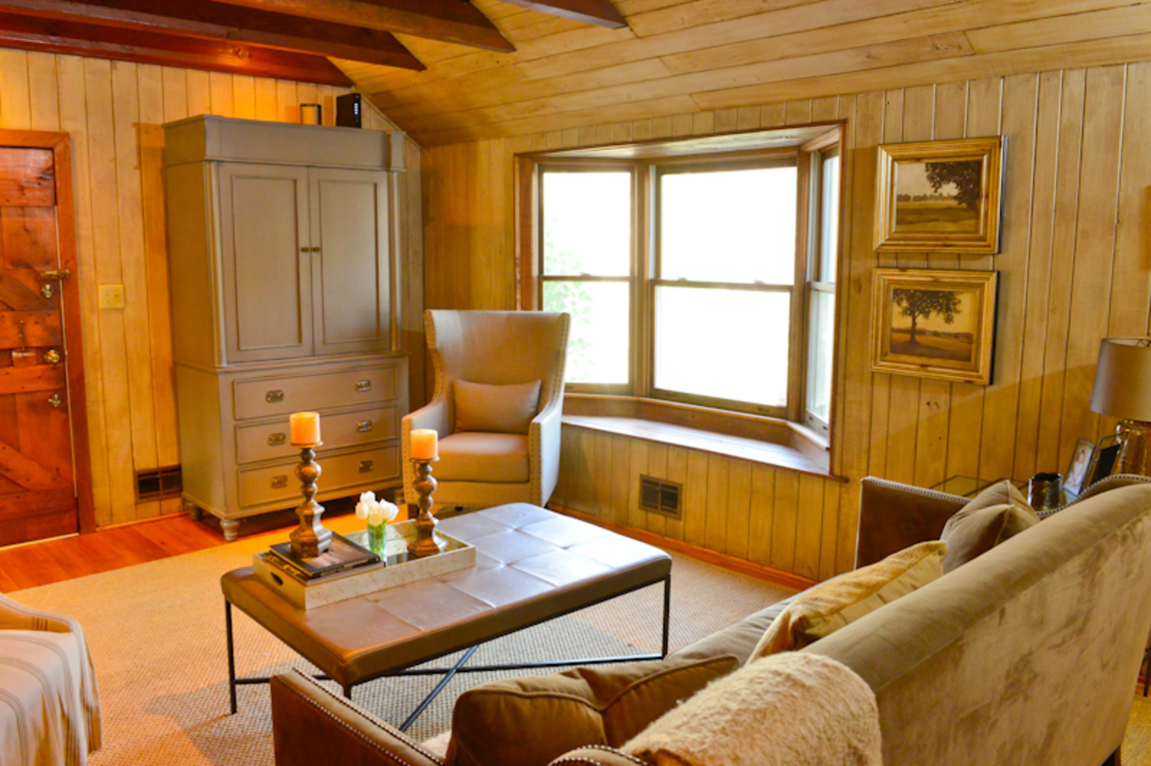 In the living room, Erin Connolly's coffee table from Bernhardt, with its leather top and metal legs, is kid-friendly. "Everything wipes off it, " she says. A sofa and chair, also from Bernhardt, and a gray armoire, from Redford House, complete the room.