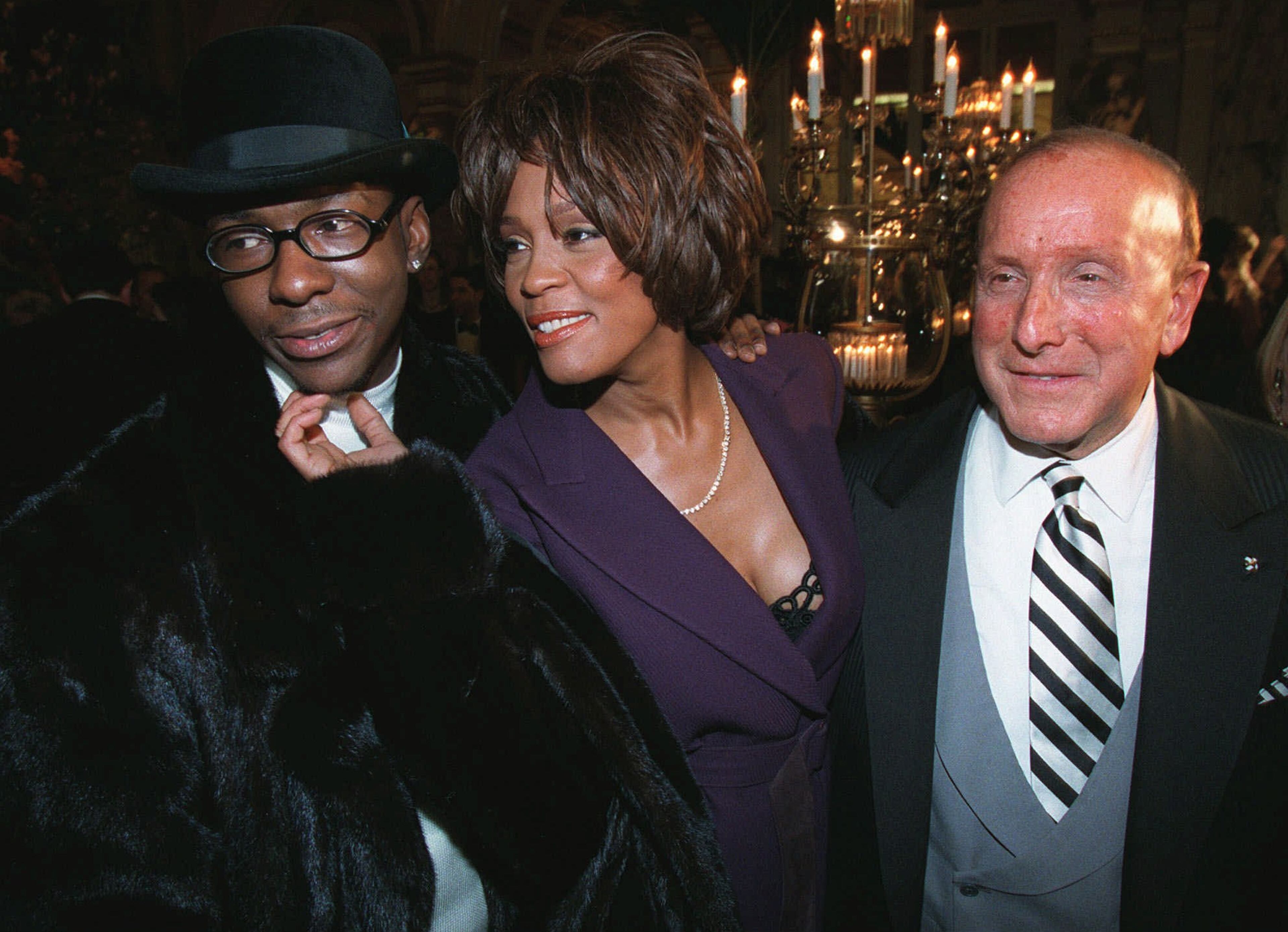 Singer Whitney Houston poses with husband Bobby Brown, left, and Clive Davis, president and founder of Arista Records, at the company's pre-Grammy party Tuesday, Feb. 24, 1998, in New York. (AP Photo/Stuart Ramson)