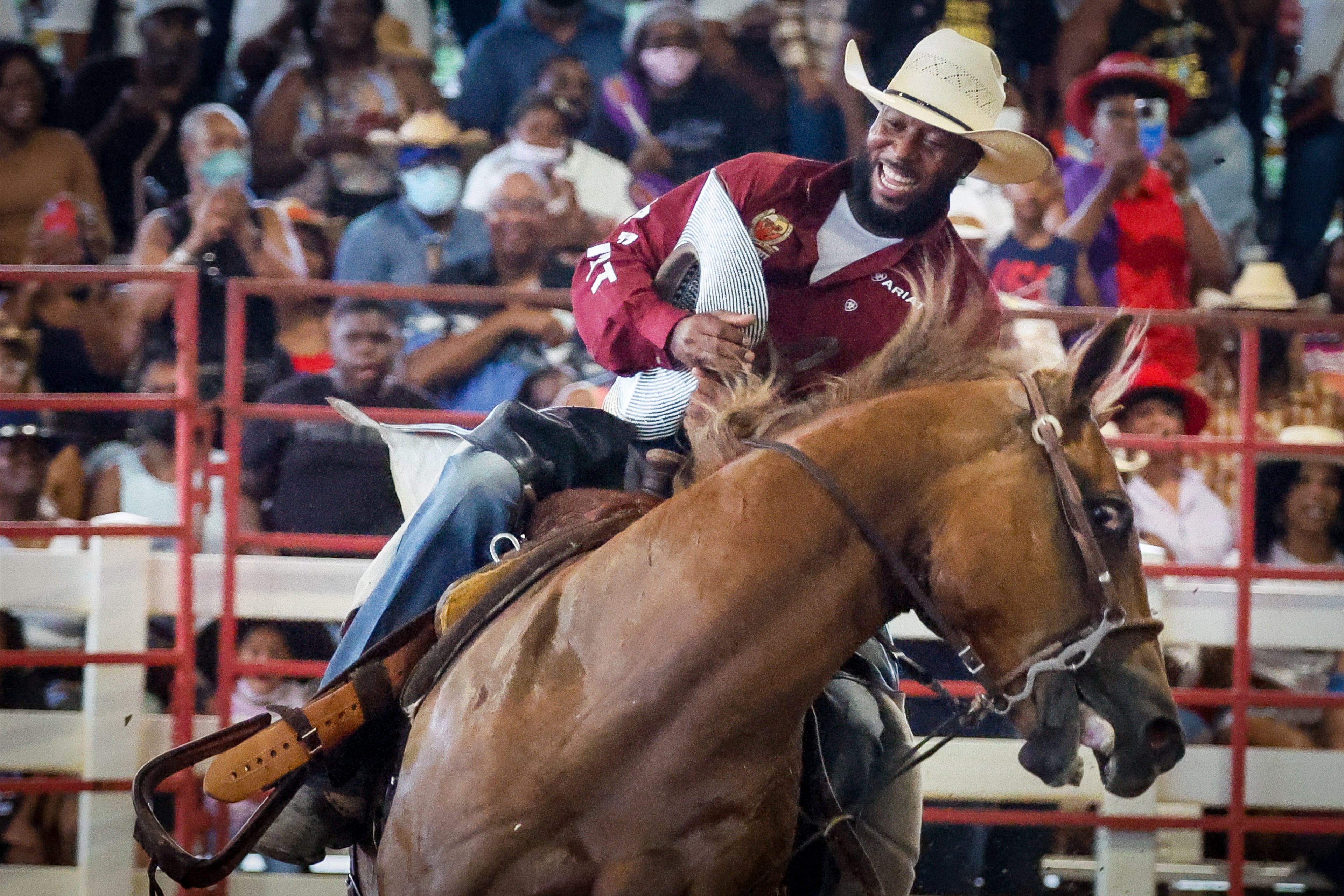 A rider hangs on during the ranch bronc riding event during the Bill Pickett Rodeo at the Georgia International Horse Park in Conyers on Saturday, August 6, 2022. The rodeo, which celebrates Black cowboys and cowgirls, saw its metro Atlanta two-day stop sell out. (Photo: Steve Schaefer / steve.schaefer@ajc.com)