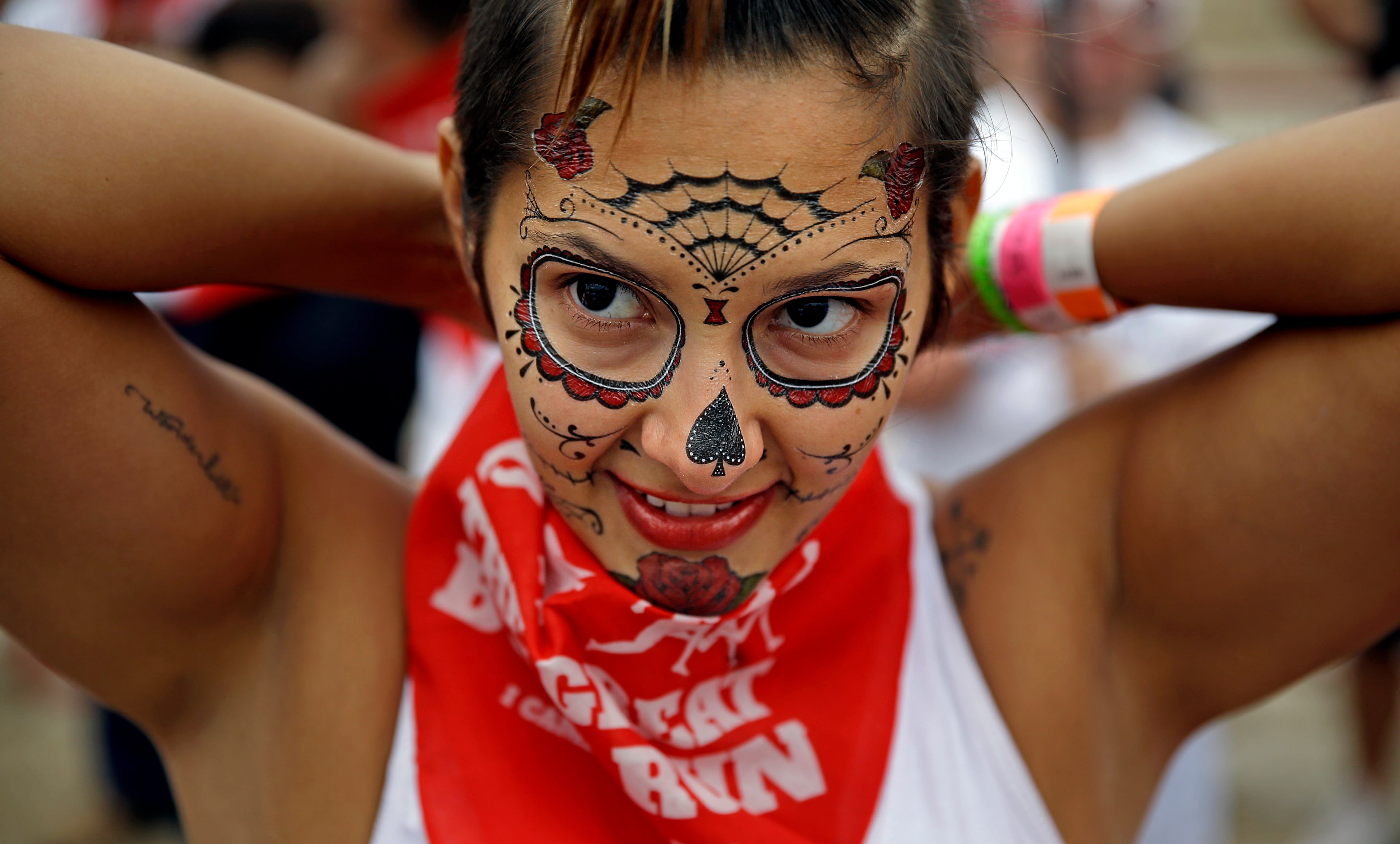 Jade Griffith ties a bandana around her neck before running alongside charging bulls during the Great Bull Run at the Georgia International Horse Park, Saturday, Oct. 19, 2013, in Conyers, Ga.