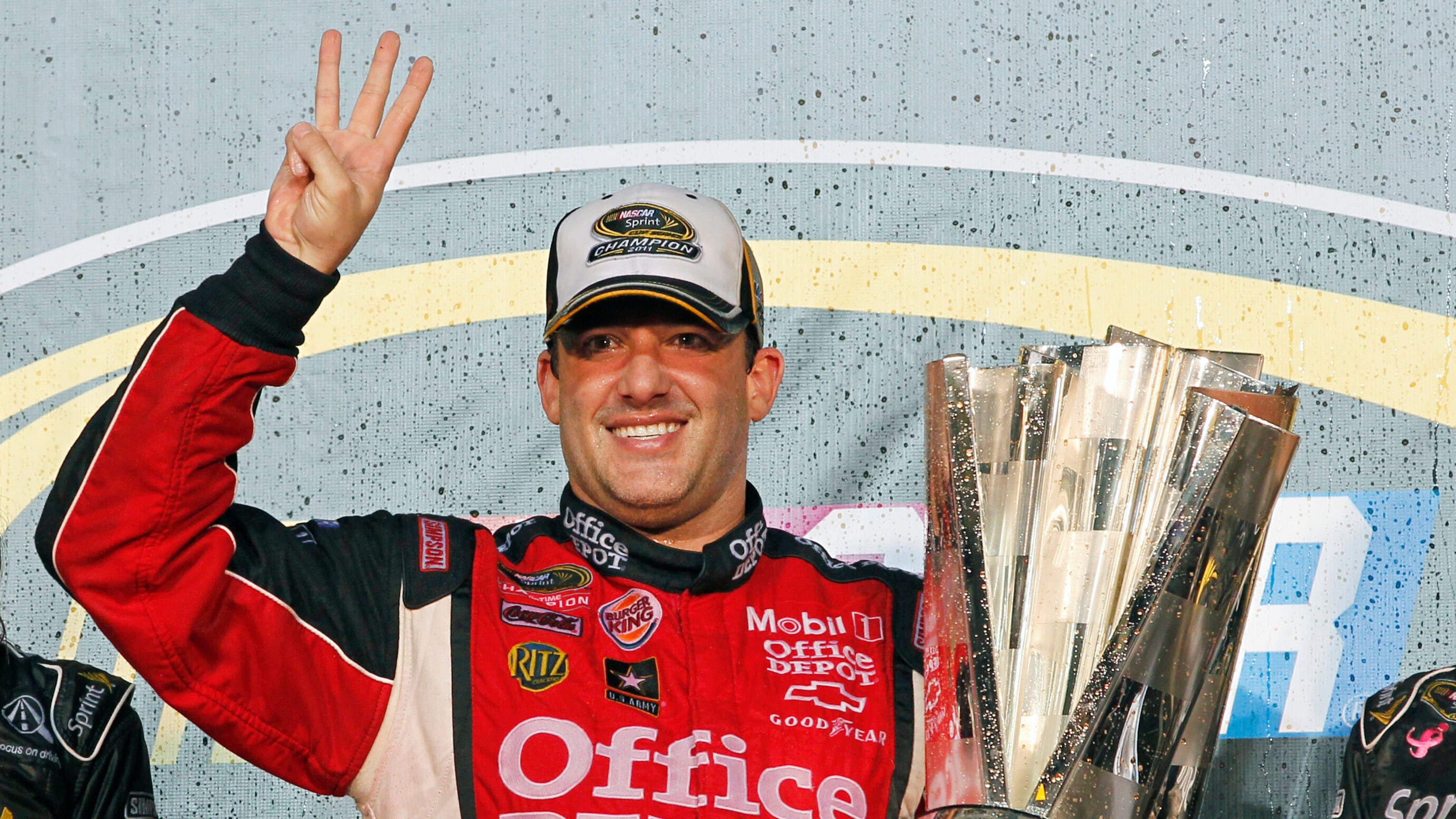 FILE - In this Nov. 20, 2011 file photo, Tony Stewart celebrates after winning his third NASCAR Sprint Cup Series championship, at Homestead-Miami Speedway in Homestead, Fla. (AP Photo/Terry Renna, File)