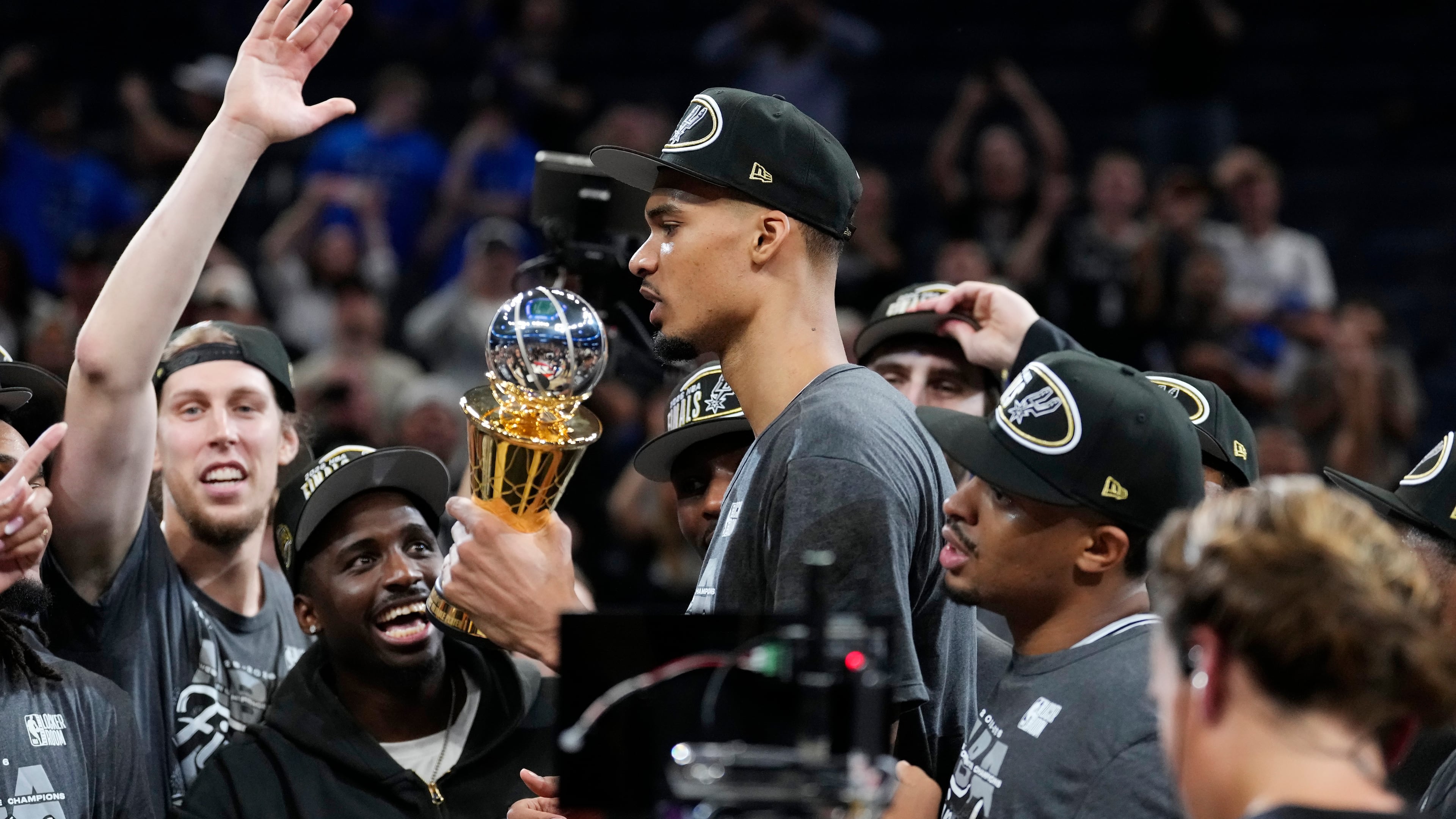 San Antonio Spurs forward Victor Wembanyama holds the MVP trophy as he celebrates with teammates after Game 7 of the Western Conference finals of the NBA basketball playoffs series win against the Oklahoma City Thunder, Saturday, May 30, 2026, in Oklahoma City. (AP Photo/Tony Gutierrez)