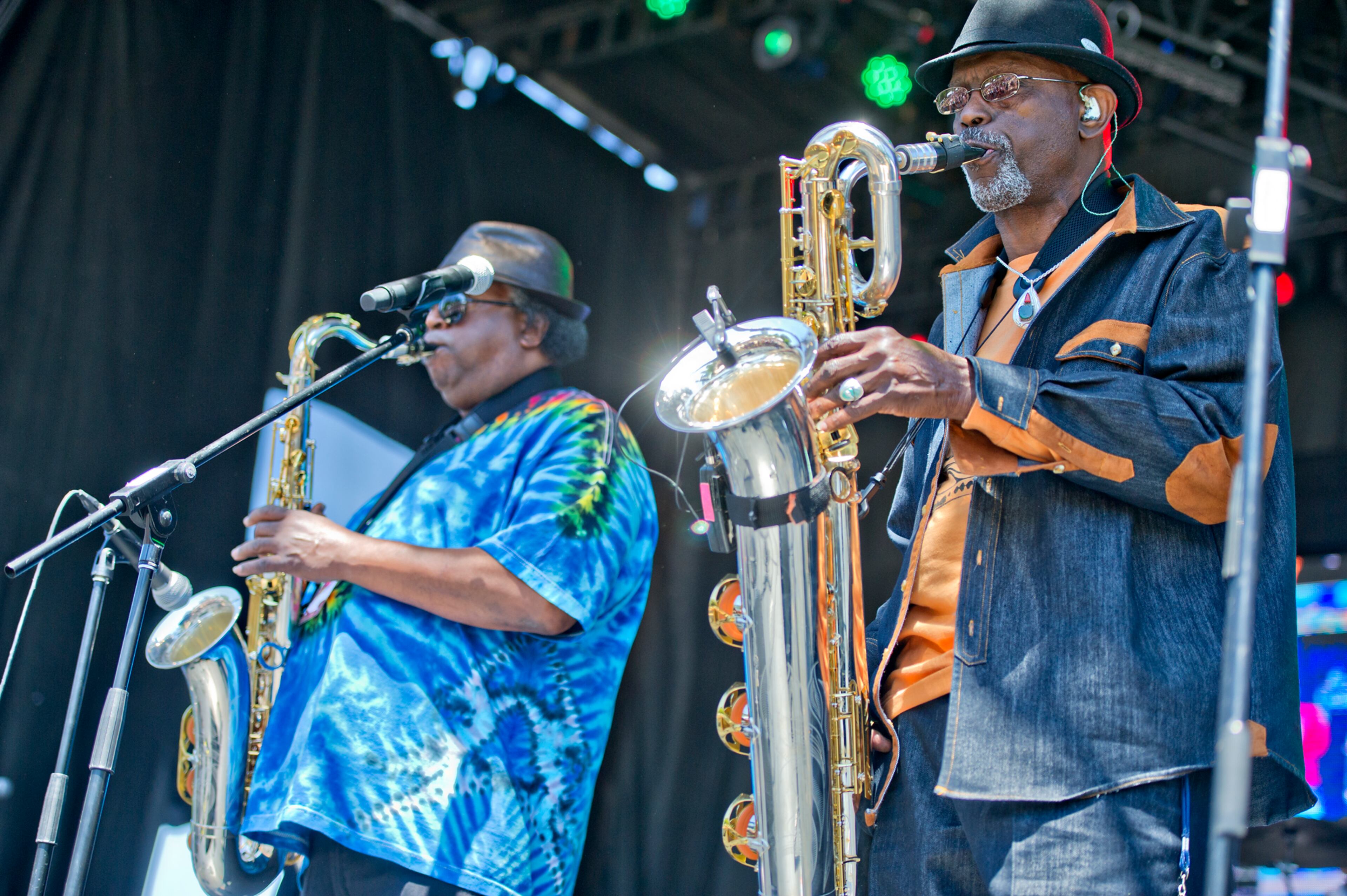 Roger Lewis (right) and Kevin Harris play their saxophones as they perform with other members of the Dirty Dozen Brass Band on stage during the Sweetwater 420 Festival at Centennial Olympic Park on Sunday, April 20, 2014.