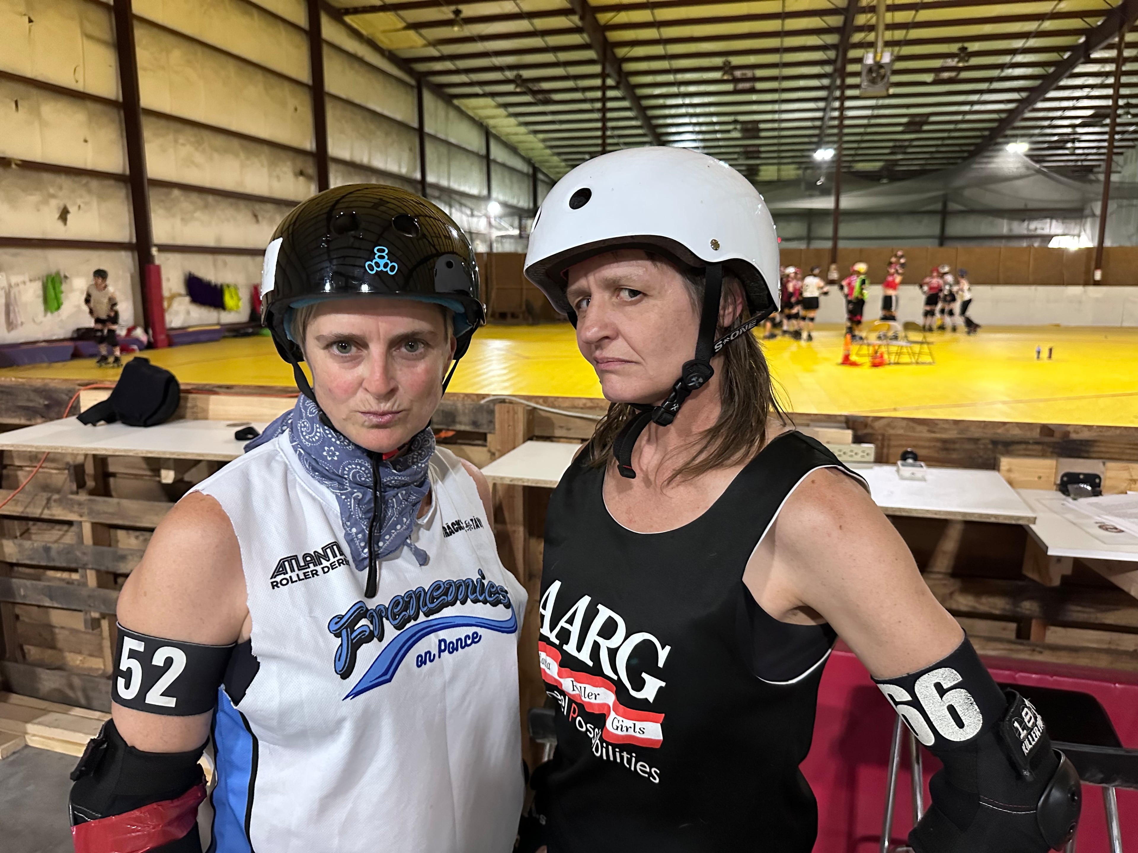 Christi Gray (aka Amelia Scarehart), left, and Jill Hennecy (aka Wheelin' Jennings) both recently came out of 10-year retirements to skate again for Atlanta Roller Derby. They posed before a scrimmage at the ARD Mableton practice facility Sept. 9, 2026. (Rodney Ho/AJC)