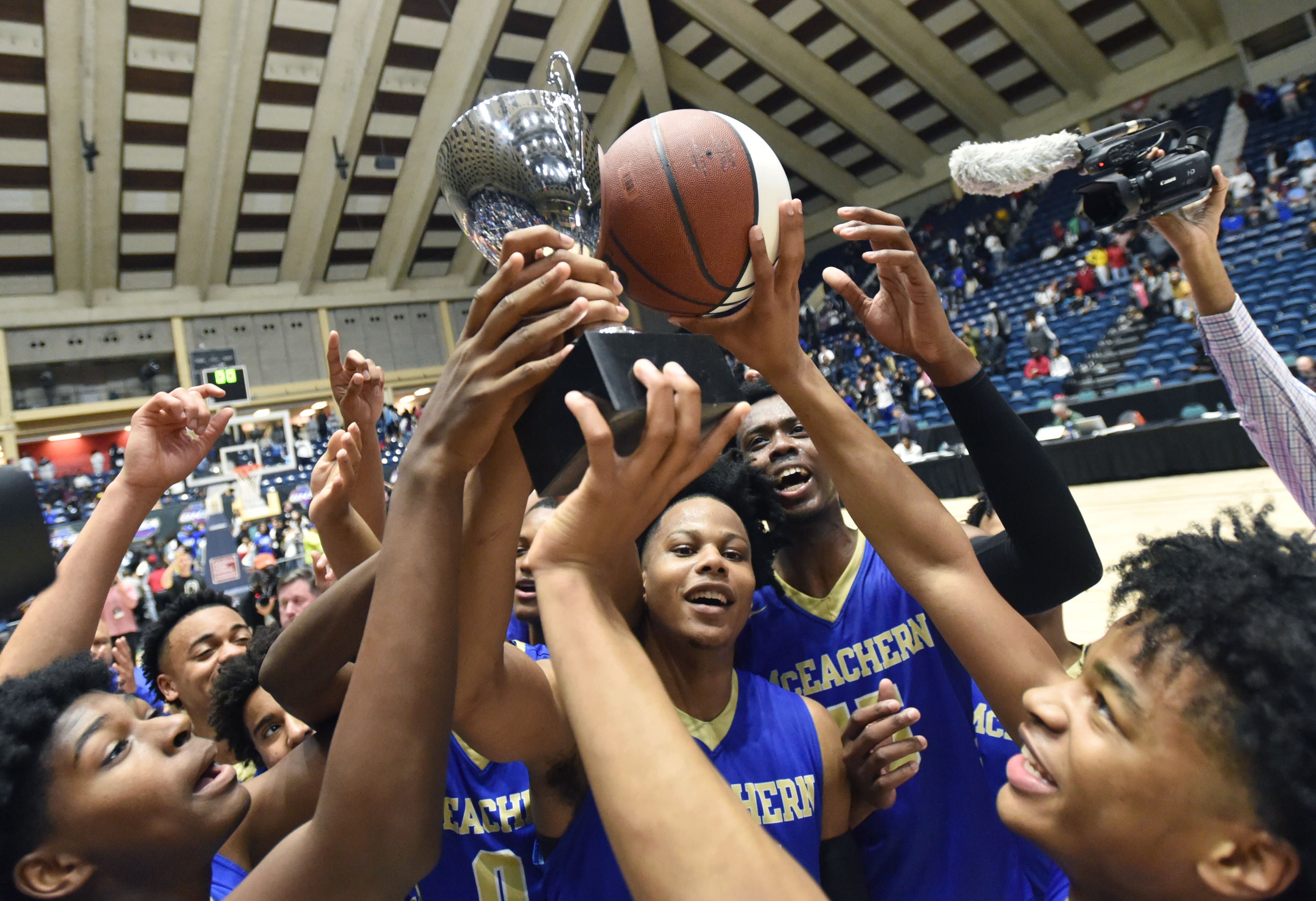 March 9, 2019 Macon - McEachern players celebrate their victory over the Meadowcreek in GHSA State Basketball Championship game at the Macon Centreplex in Macon on Saturday, March 9, 2019. McEachern won 62-54 over the Meadowcreek. HYOSUB SHIN / HSHIN@AJC.COM