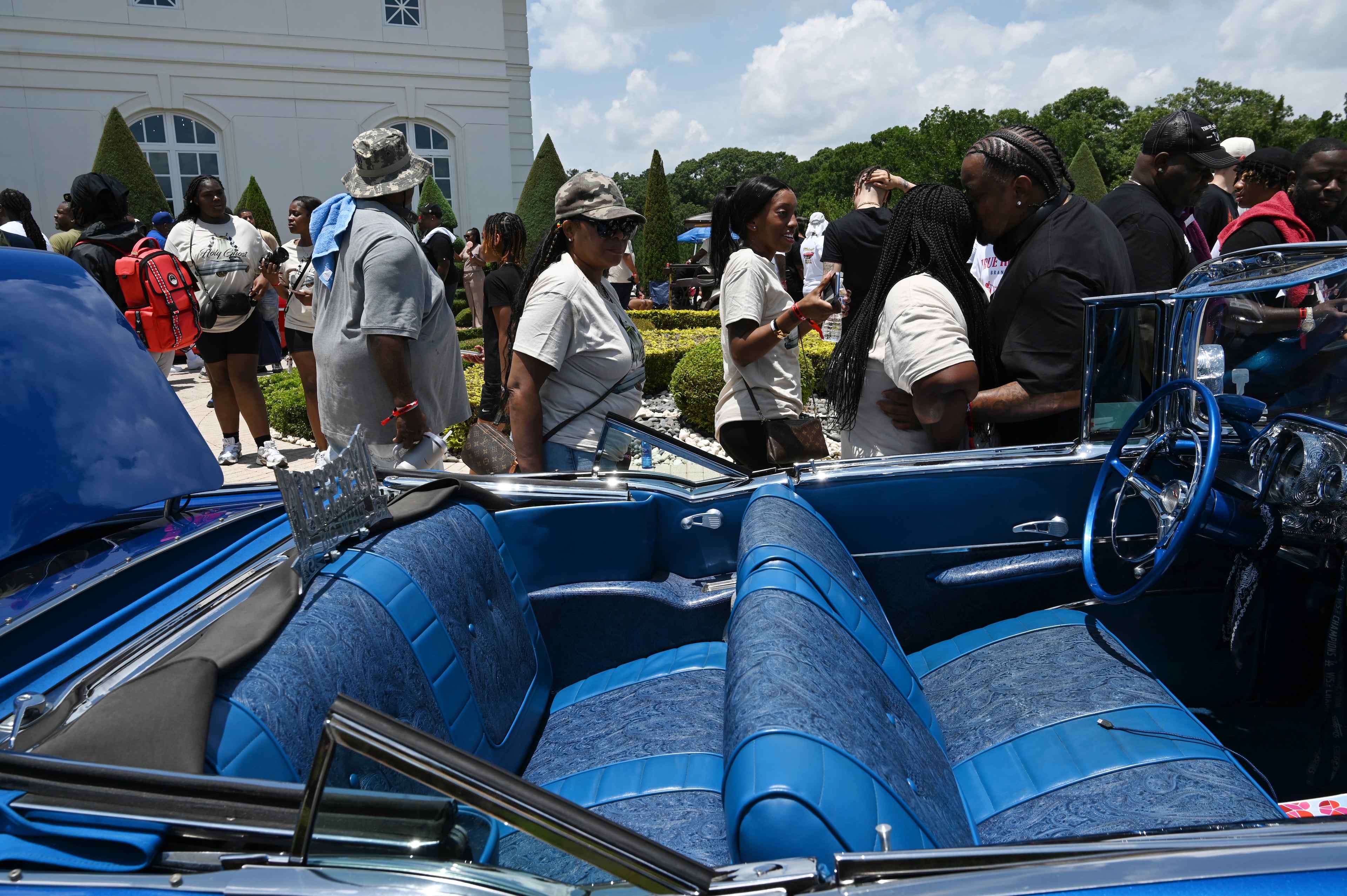 Custom blue 1957 Chevrolet Bel Air that Ice Cube drove onto the field at Dodger Stadium on Opening Day is displayed during the 4th Annual Rick Ross Car and Bike Show, Saturday, June 7, 2025, in Fayetteville. The 4th Annual Rick Ross Car and Bike Show will include a vendor market with more than 30 vendors, food trucks, fleets of classic/custom automobiles, luxury vehicles, boats, RVs and trailers on the front of the mansion. Stage performances include Plies, Ross' new signee Nino Breeze and Ross himself. (Hyosub Shin / AJC)