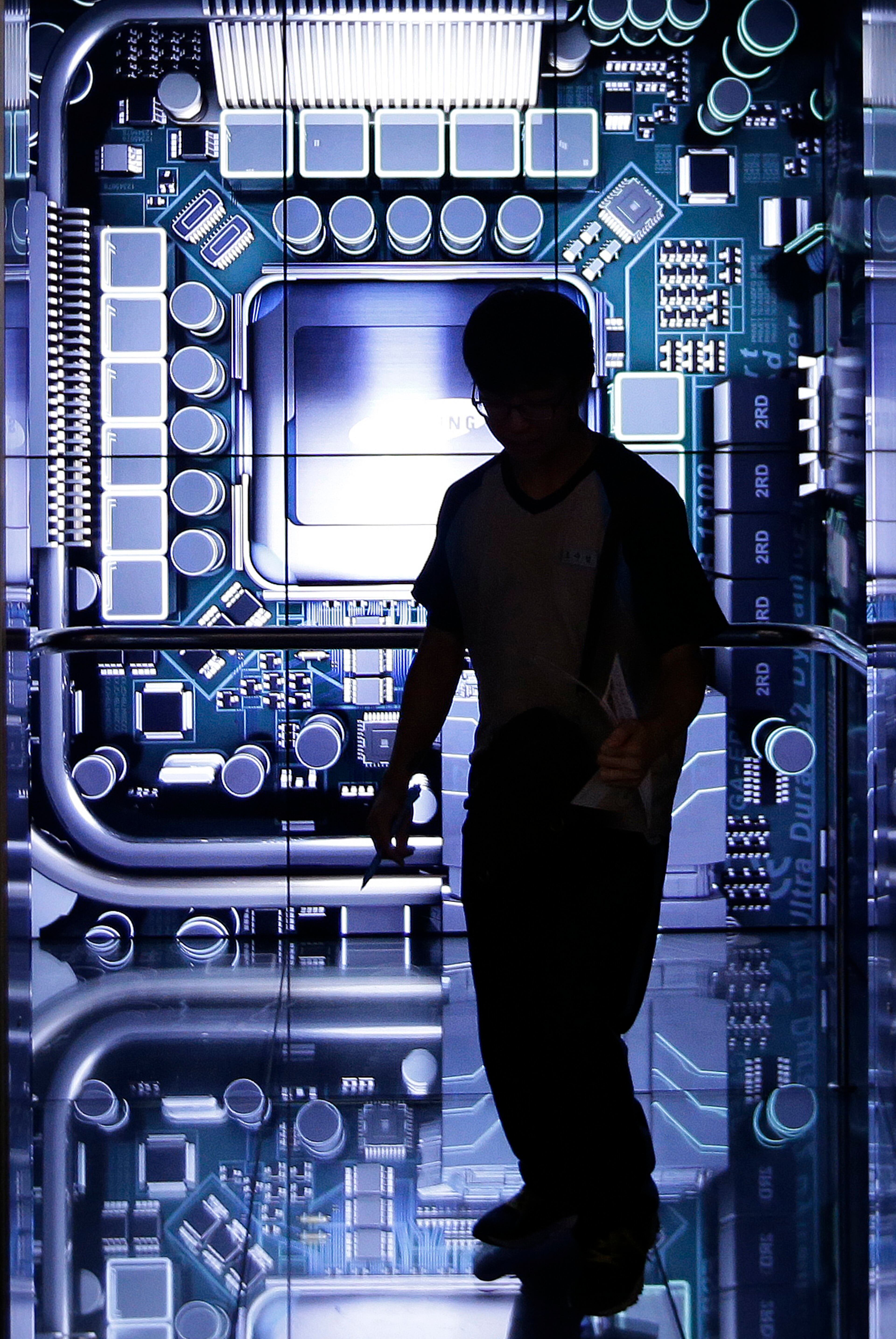 A man visits the Samsung Electronics Co.'s showroom in Seoul, South Korea, Tuesday, Oct. 7, 2014. Samsung Electronics Co. said Tuesday its third-quarter operating profit is estimated to have fallen to the lowest level in more than three years, as Galaxy handsets sales slow. (AP Photo/Ahn Young-joon)