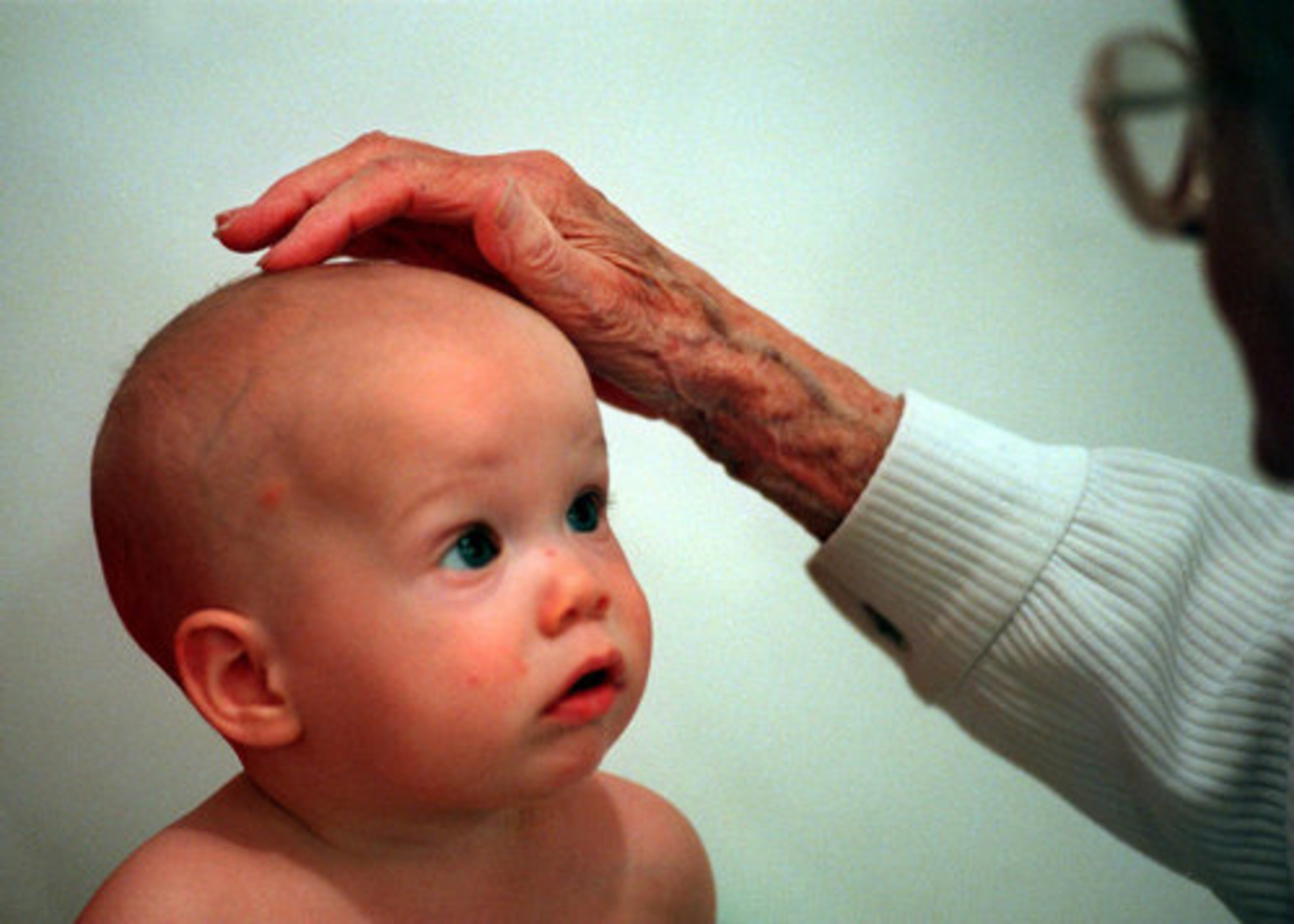 Denmark touches 7-month-old Zachary Moore on the head during a routine exam in 1998. Denmark, who lived and worked in and around Atlanta starting in the '20s, moved to Athens to live with her daughter a few years ago.