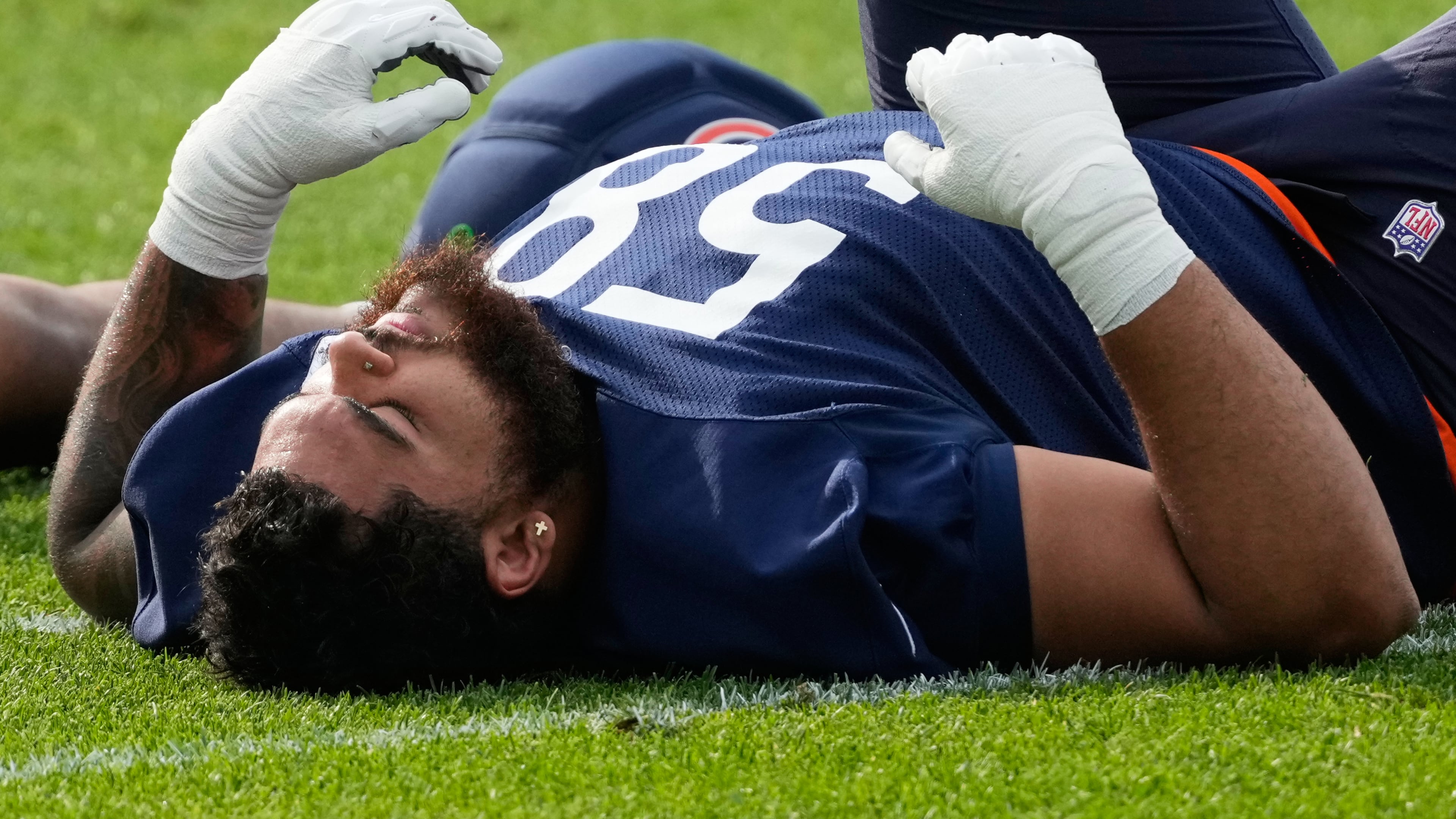 Chicago Bears offensive line Darnell Wright warms up during practice at the team's NFL football training camp, Friday, July 31, 2026, in Lake Forest, Ill. (AP Photo/Nam Y. Huh)
