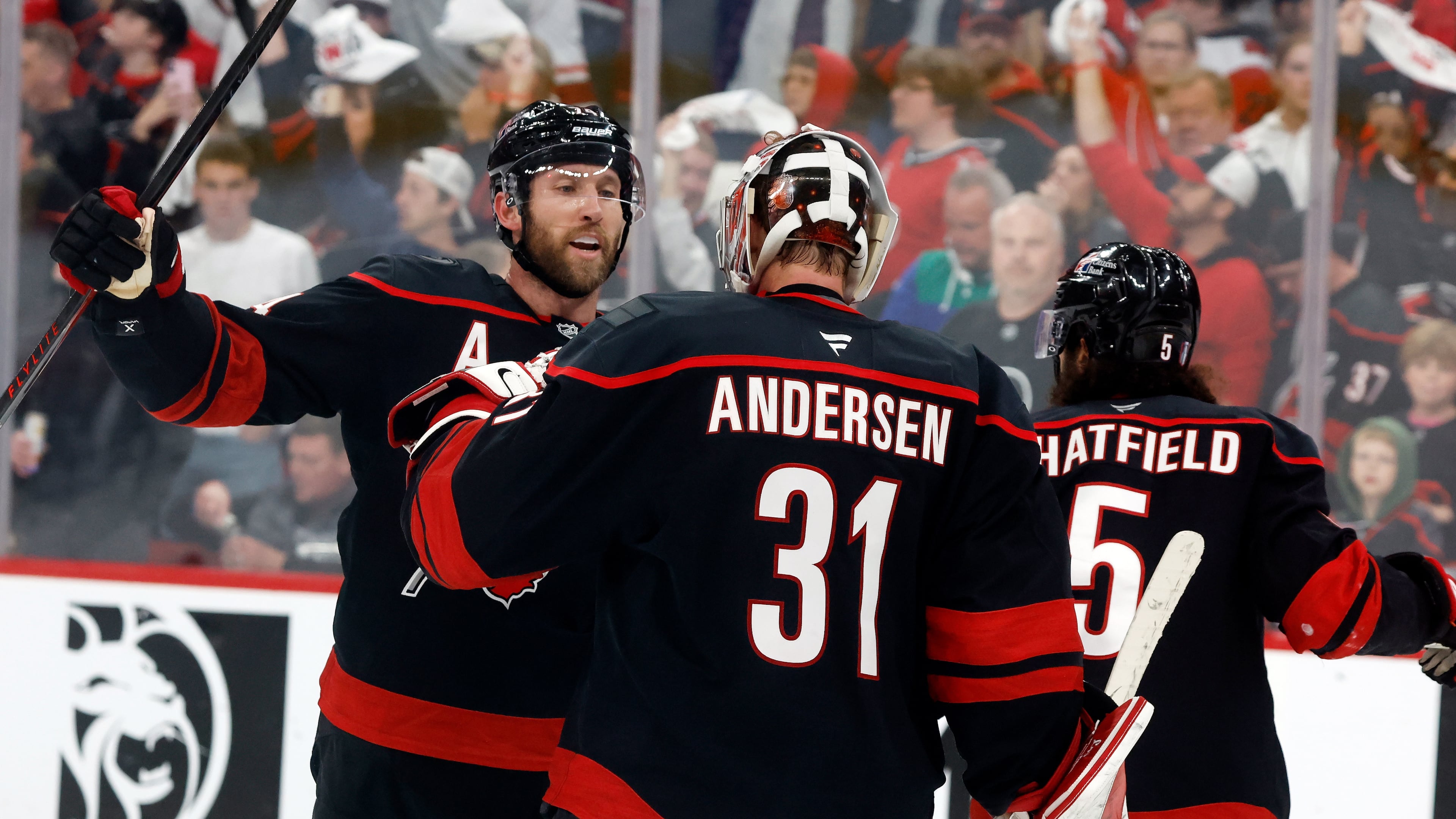 Carolina Hurricanes goaltender Frederik Andersen (31) is congratulated by Jaccob Slavin, left, following Game 1 of an NHL hockey Stanley Cup second-round playoff series against the Philadelphia Flyers in Raleigh, N.C., Saturday, May 2, 2026. (AP Photo/Karl DeBlaker)