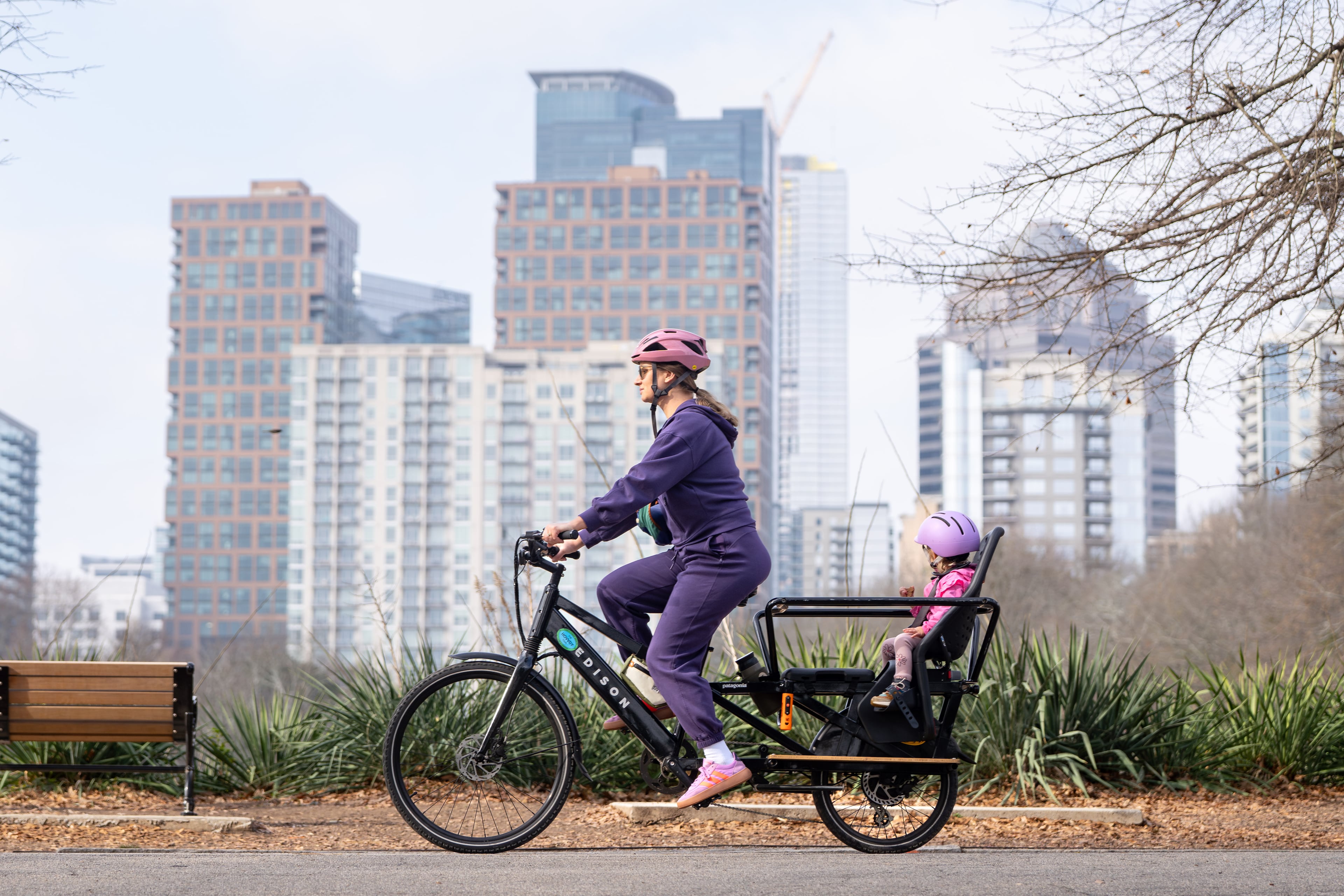 A woman and child ride an e-bike through Piedmont Park amid unusually warm weather on Wednesday, Jan. 7, 2026, in Atlanta. (Ben Hendren for the AJC)