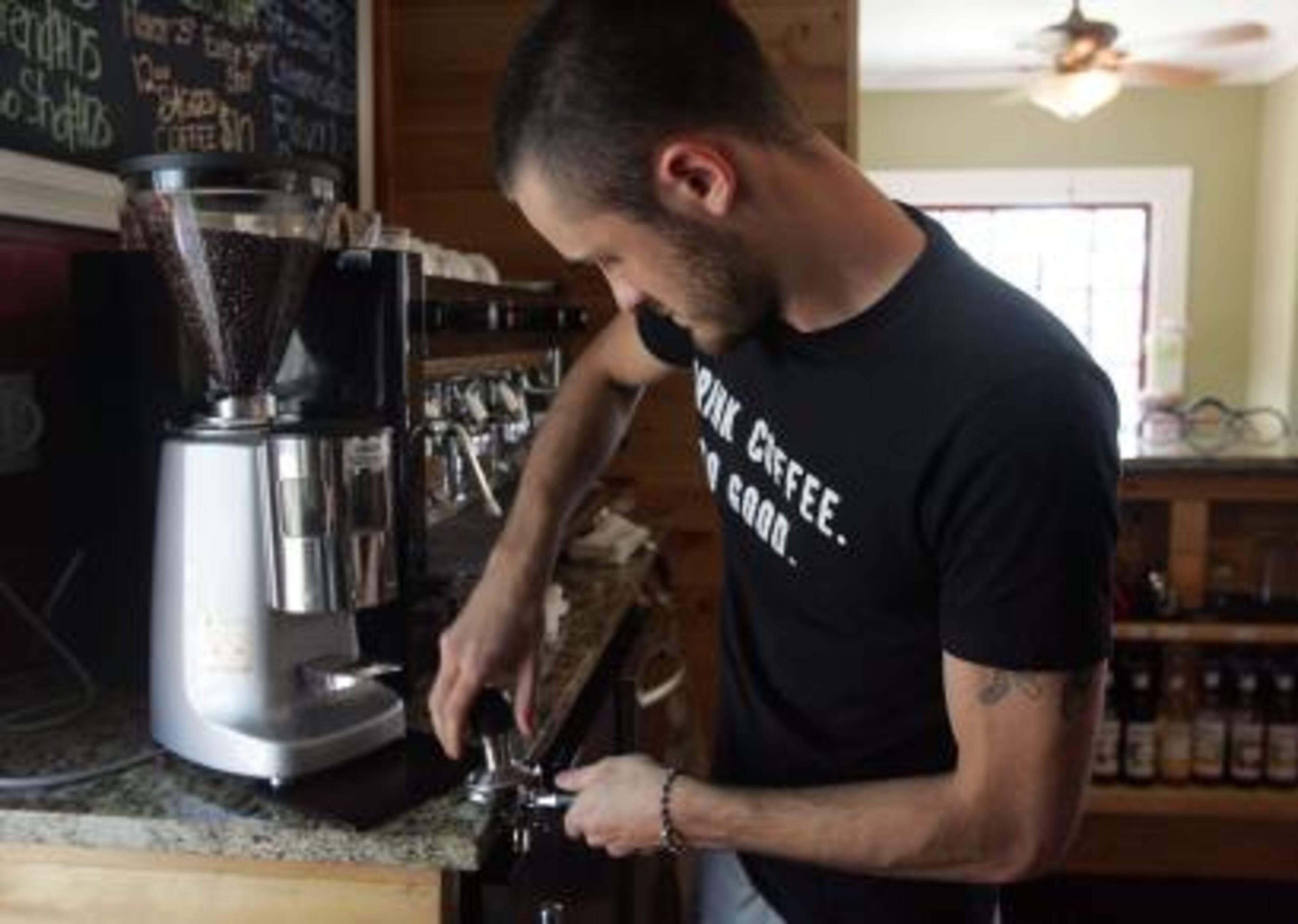 Matt Davis works behind the counter at the Land of 1000 Hills Coffee Co.