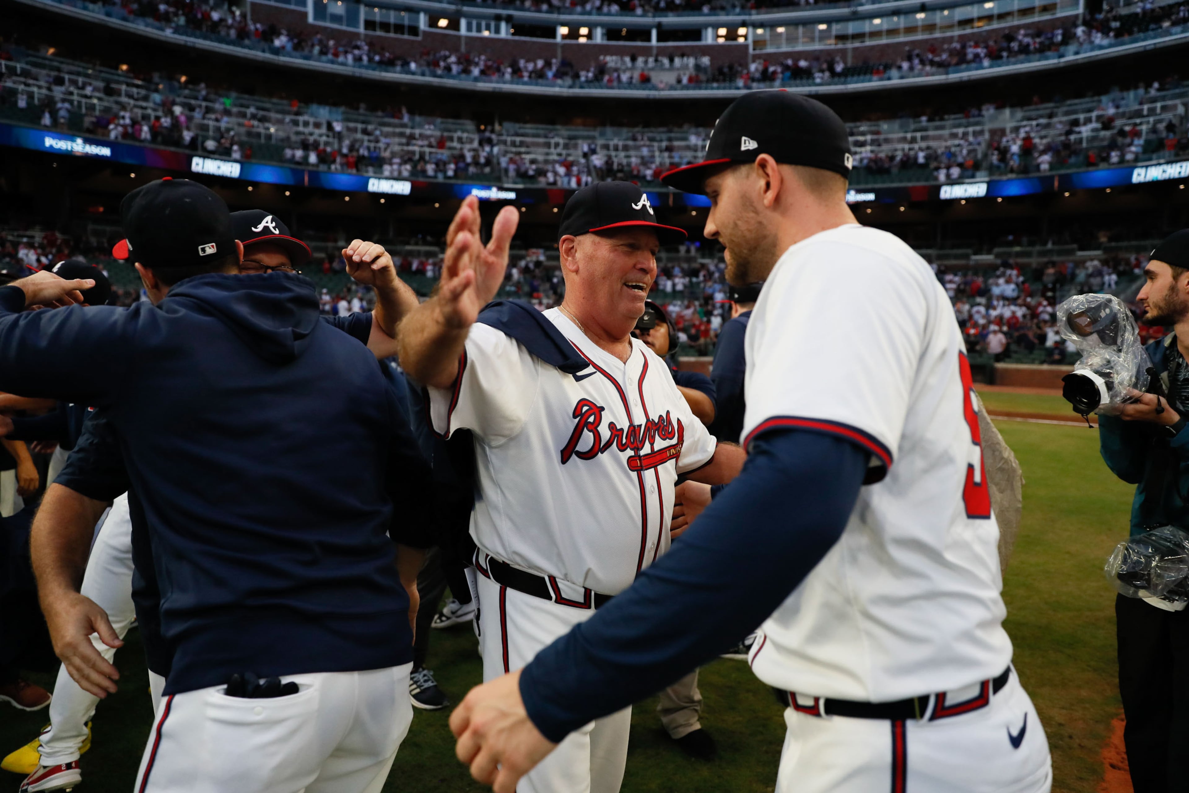 Atlanta Braves manager Brian Snitker celebrates with pitcher Dylan Lee.
(Miguel Martinez/ AJC)