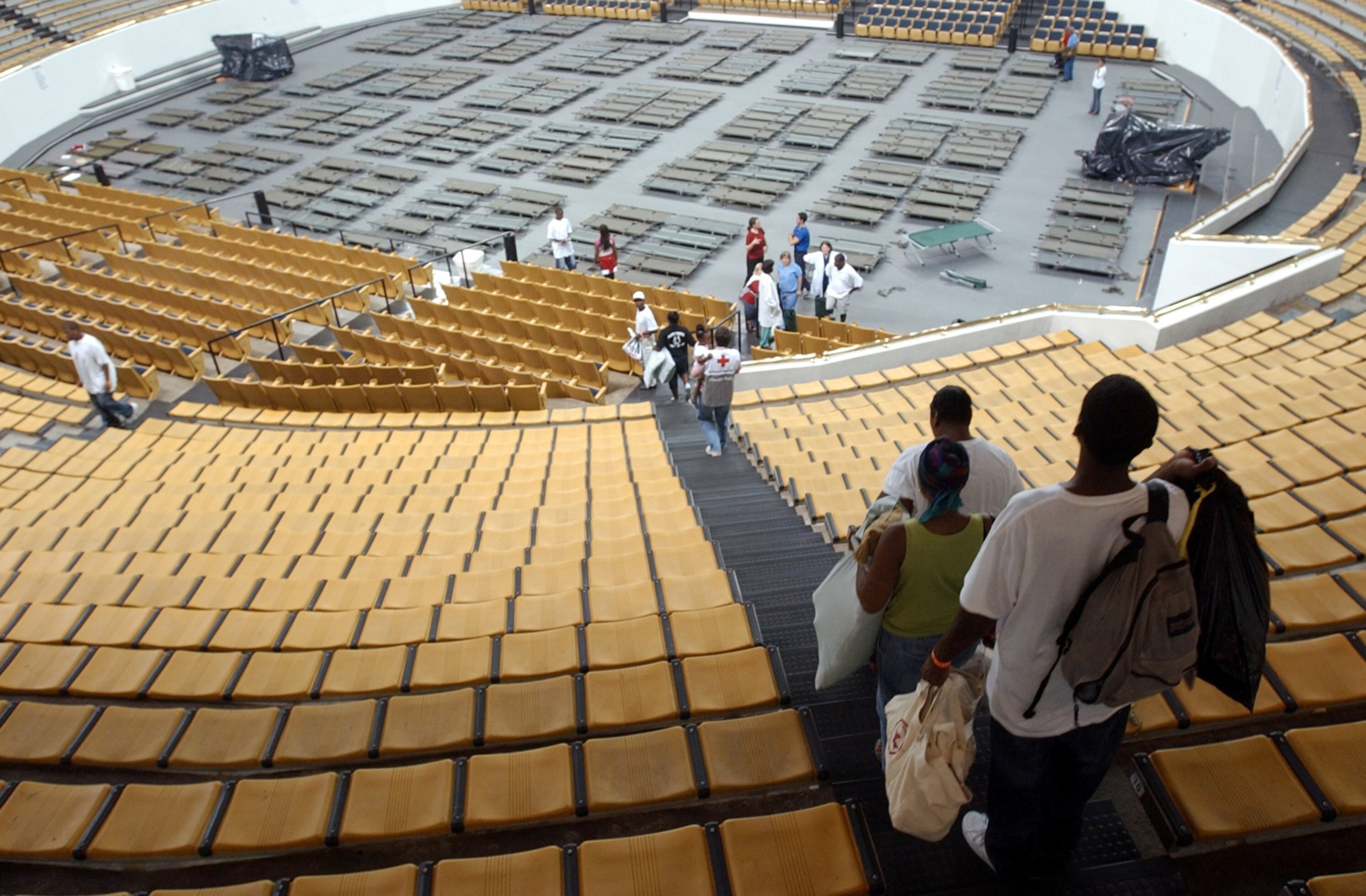 050902 - ATLANTA, GA -- Hurricane Katrina refugees were moved from the Adamsville Recreation Center to Georgia Tech's Alexander Coliseum Friday, September 2, 2005. Unidentified refugees walk the steps down to the Coliseum floor at Tech. (W.A. BRIDGES JR./AJC staff)
