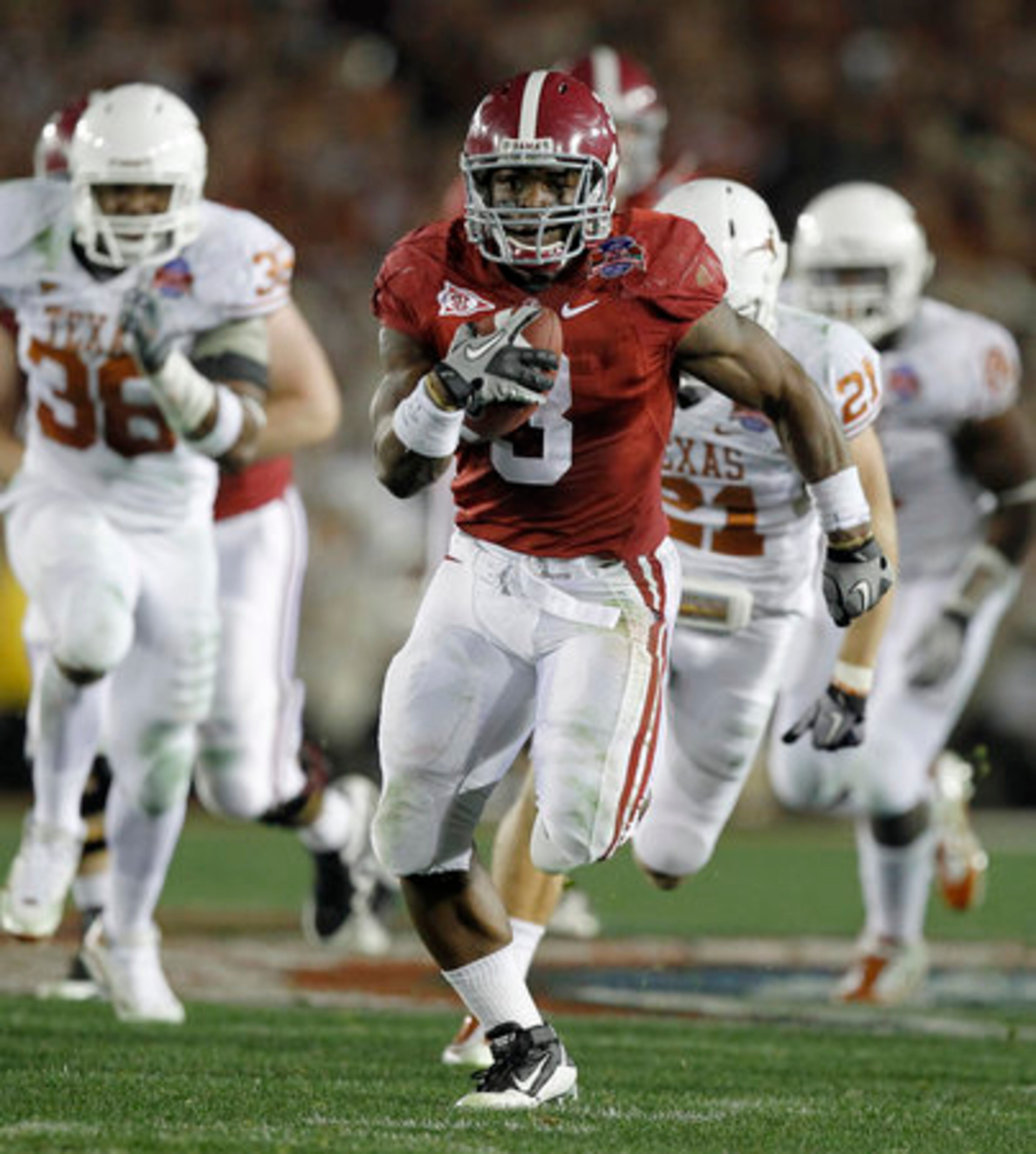 Alabama running back Trent Richardson (3) evades Texas defenders to score a 49-yard touchdown during the second quarter.