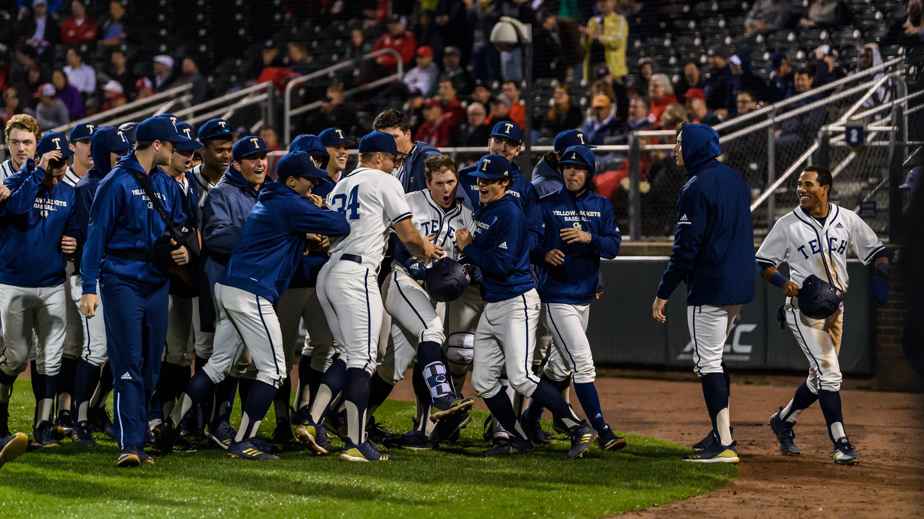 Georgia Tech shortstop Luke Waddell (holding helmet in hand) is mobbed by teammates after his fifth-inning home run against Georgia in the Yellow Jackets' 11-2 win over the Bulldogs March 26, 2019 at Russ Chandler Stadium. (Danny Karnik/Georgia Tech Athletics)