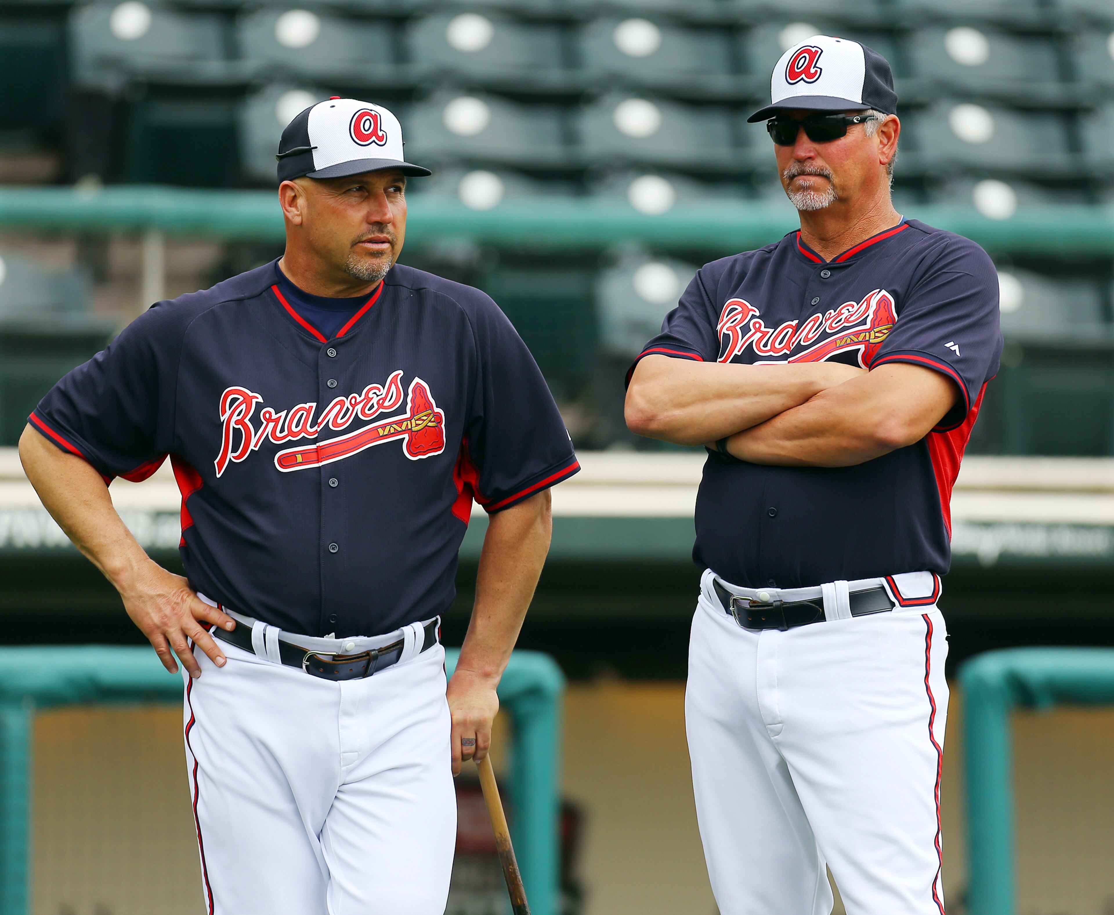 Braves coach Greg Walker and manager Fredi Gonzalez watch over team batting practice at spring training on Friday, Feb. 21, 2014, in Lake Buena Vista, FL. CURTIS COMPTON / CCOMPTON@AJC.COM