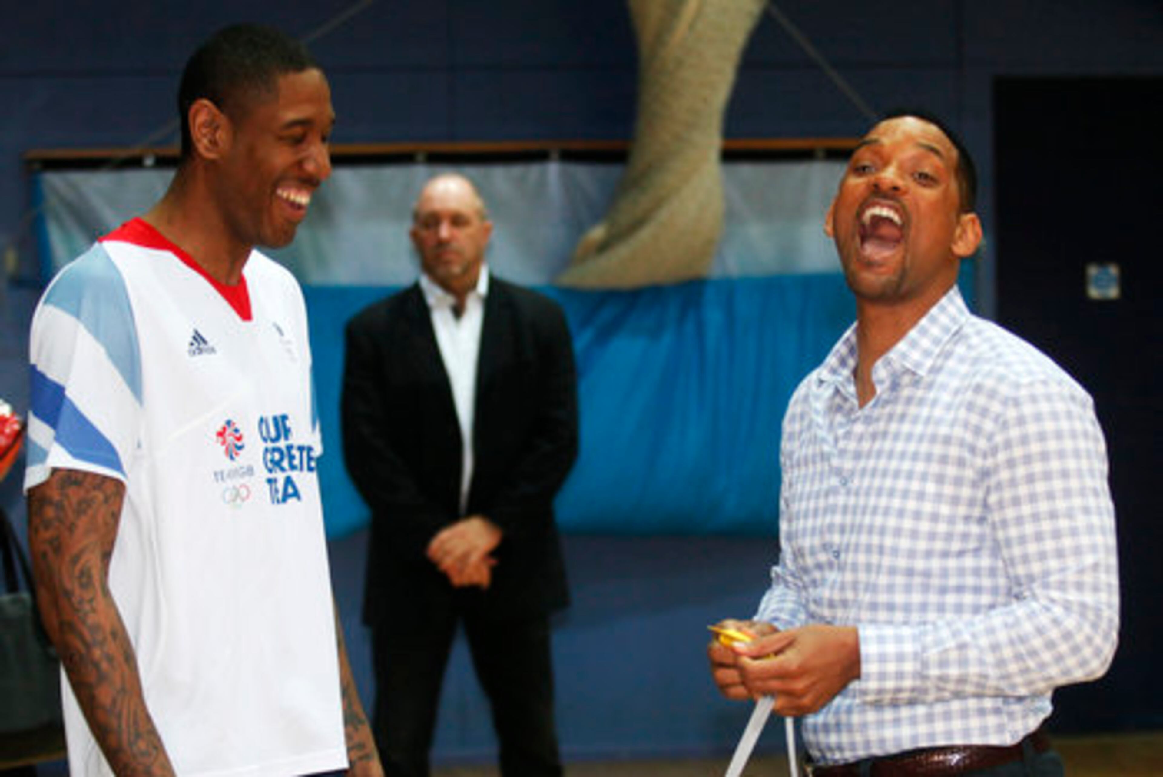 Great Britain Olympic team basketball captain Drew Sullivan presents Will Smith the gold medal.
