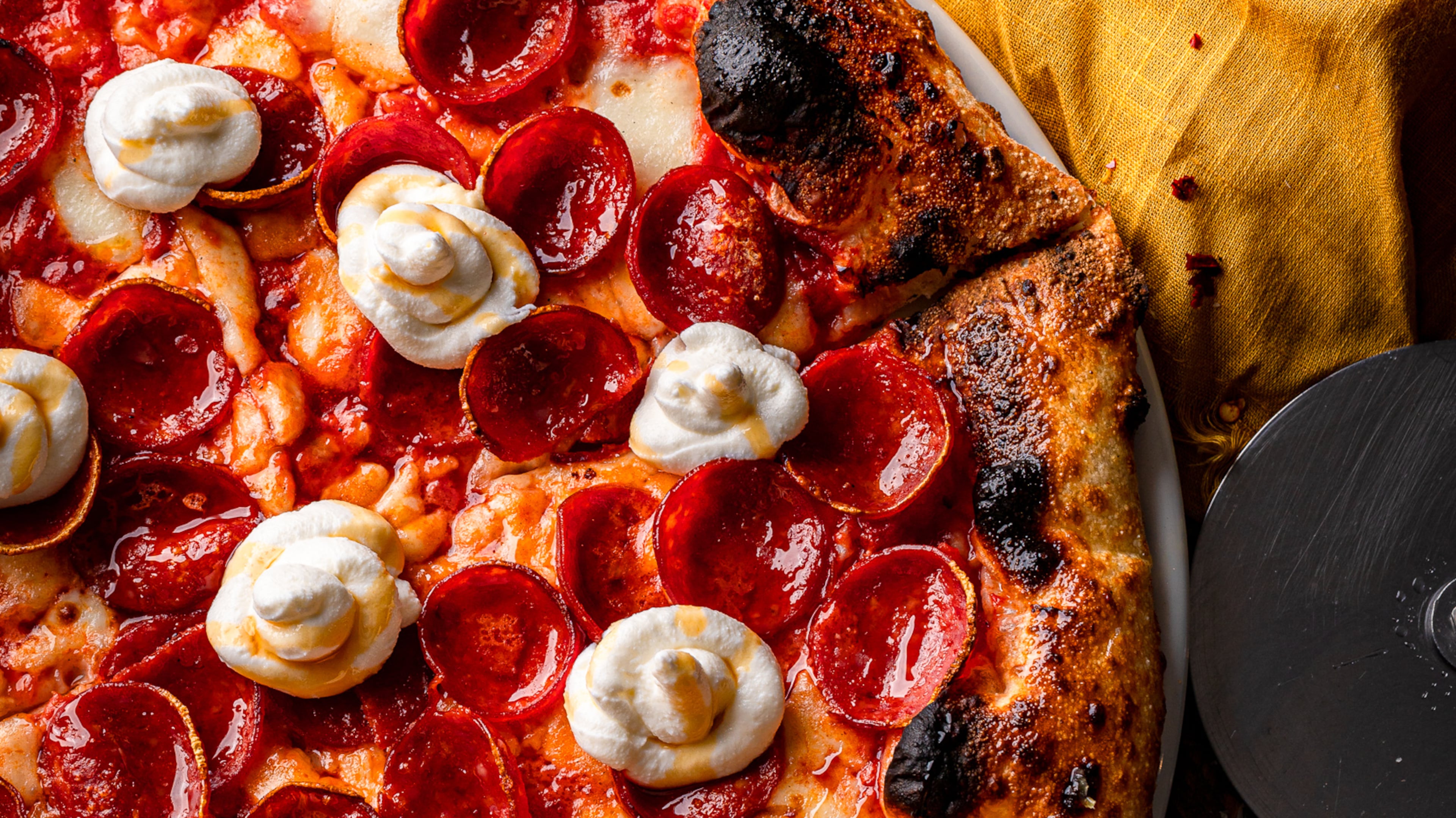 Topped with tomato sauce, fresh mozzarella, Parmesan, pepperoni, plus dabs of ricotta and hot honey, the Hot Honey Char pizza is a satisfying combination of savory, sweet, salty and spicy. RYAN AARON PHOTO