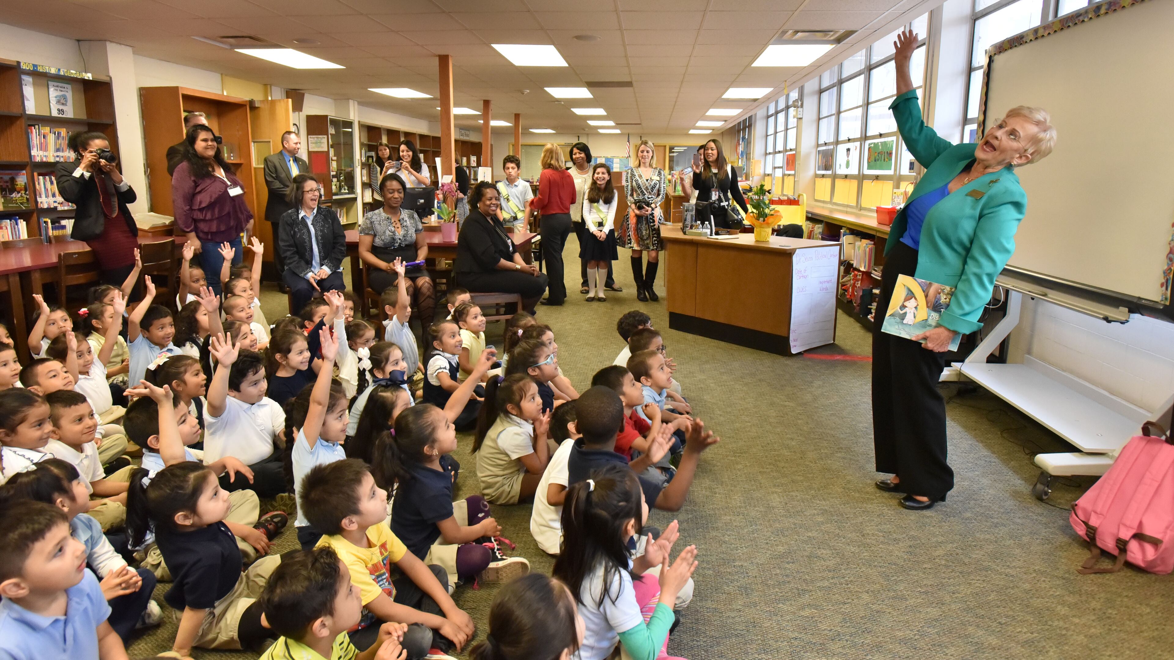 Georgia First Lady Sandra Deal interacts with pre-kindergarten students as she reads TJ's Discovery to promote Read Across Georgia Month, a campaign that supports increased childhood literacy in the state, at Woodward Elementary School on Thursday, March 12, 2015. Made with a Nikon D750 camera, 17-35MM lens at focal length 19MM, 1/250 second, F5, and an ISO of 3200. HYOSUB SHIN / HSHIN@AJC.COM